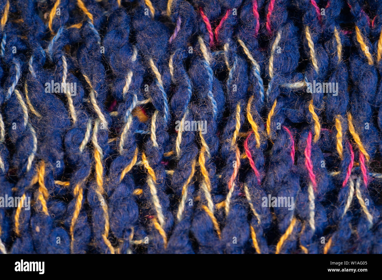 Texture knitted fabric. Warm sweater made of different color yarn. Creative vintage background Stock Photo