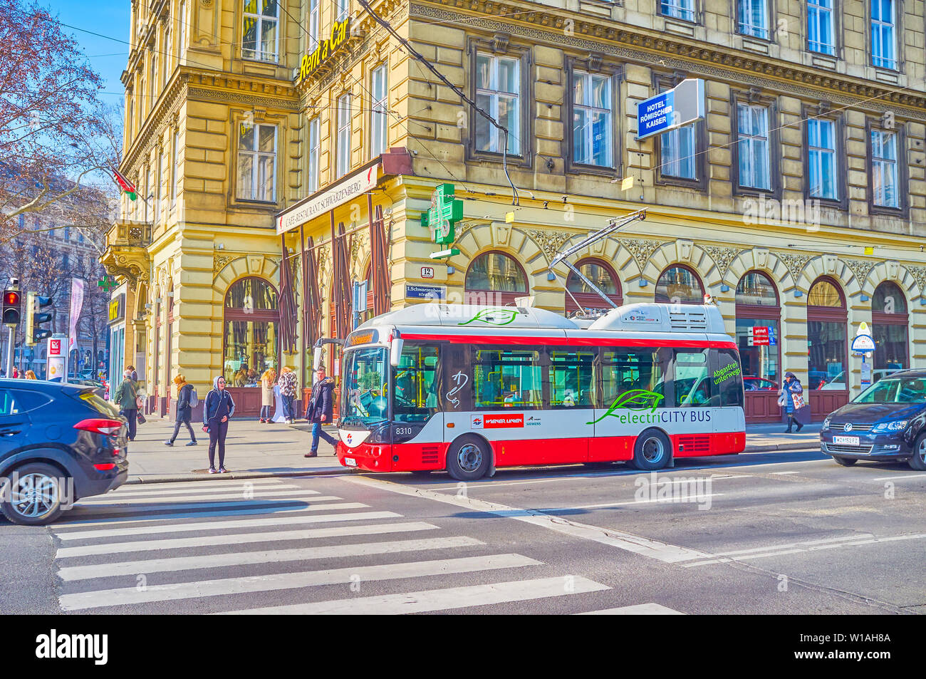 VIENNA, AUSTRIA - FEBRUARY 18, 2019: The small modern electric bus with folding poles is the ideal choice for tight streets in historical center, on F Stock Photo