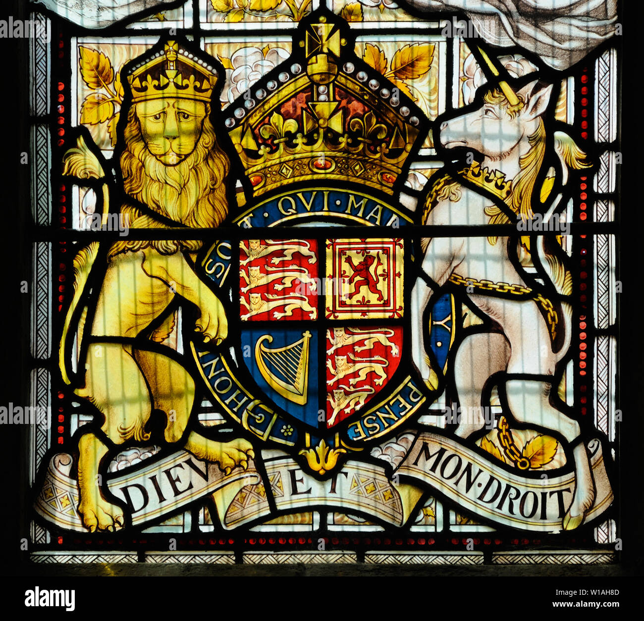 The royal arms in stained glass (c.1887) by Heaton, Butler & Bayne in the Church of the Holy Innocents, Great Barton, Suffolk, England Stock Photo