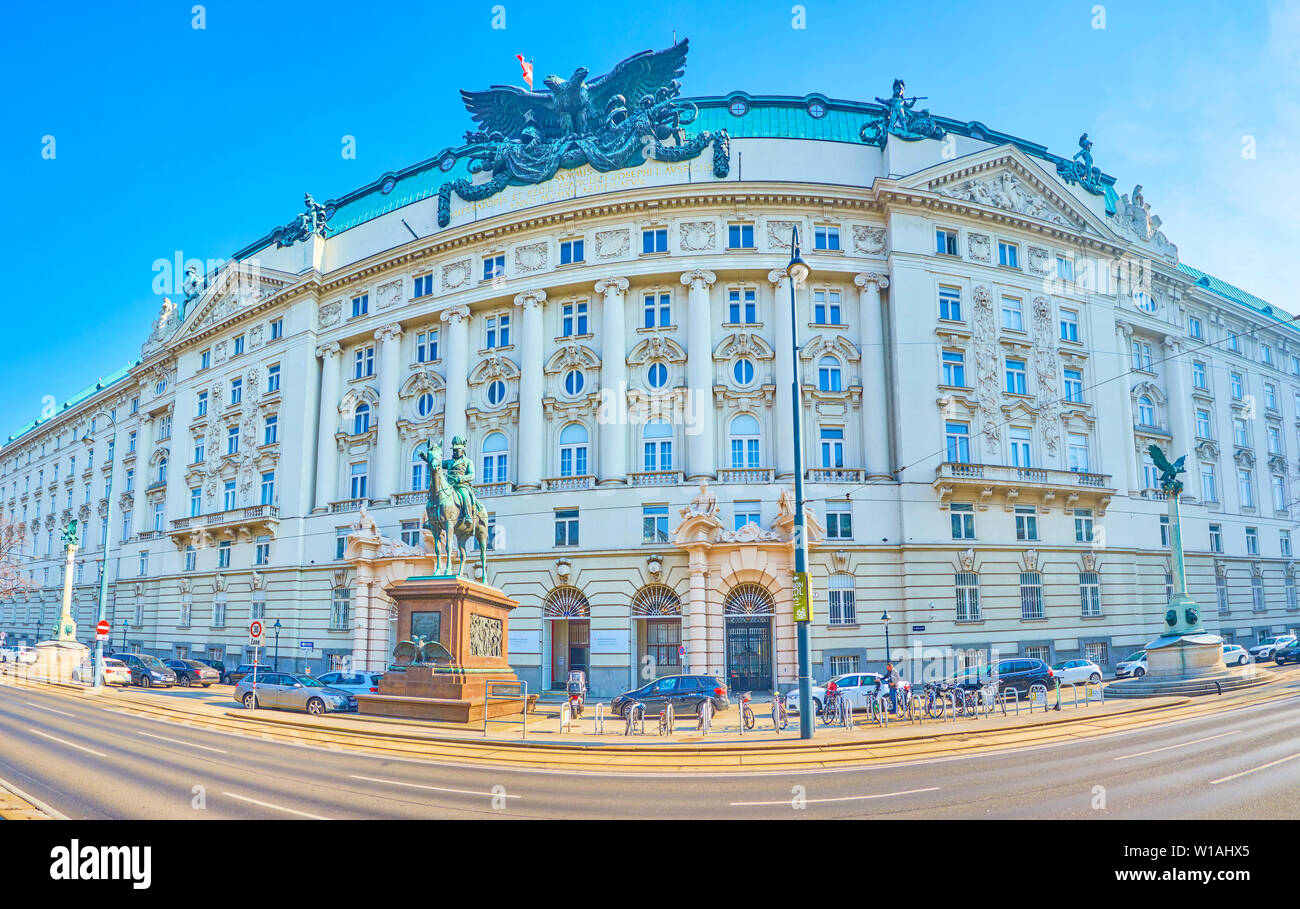 VIENNA, AUSTRIA - FEBRUARY 18, 2019: The panoramic view on  facade of Government building with large double eagle sculpture on the top and monument to Stock Photo