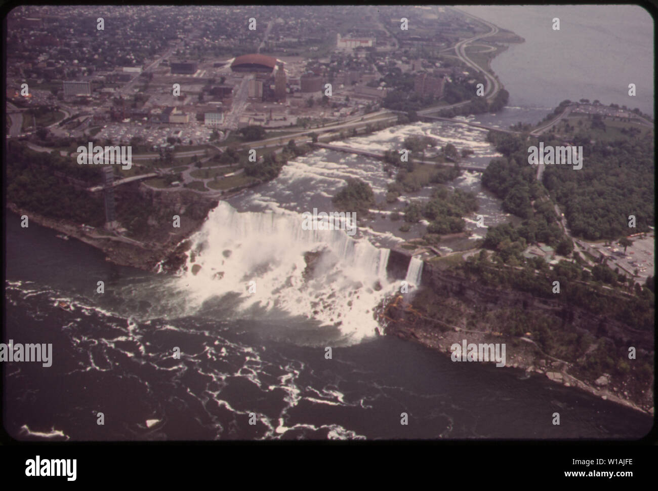 AMERICAN NIAGARA FALLS SEEN FROM THE AIR. FOAM CHURNING AT THE BASE IS