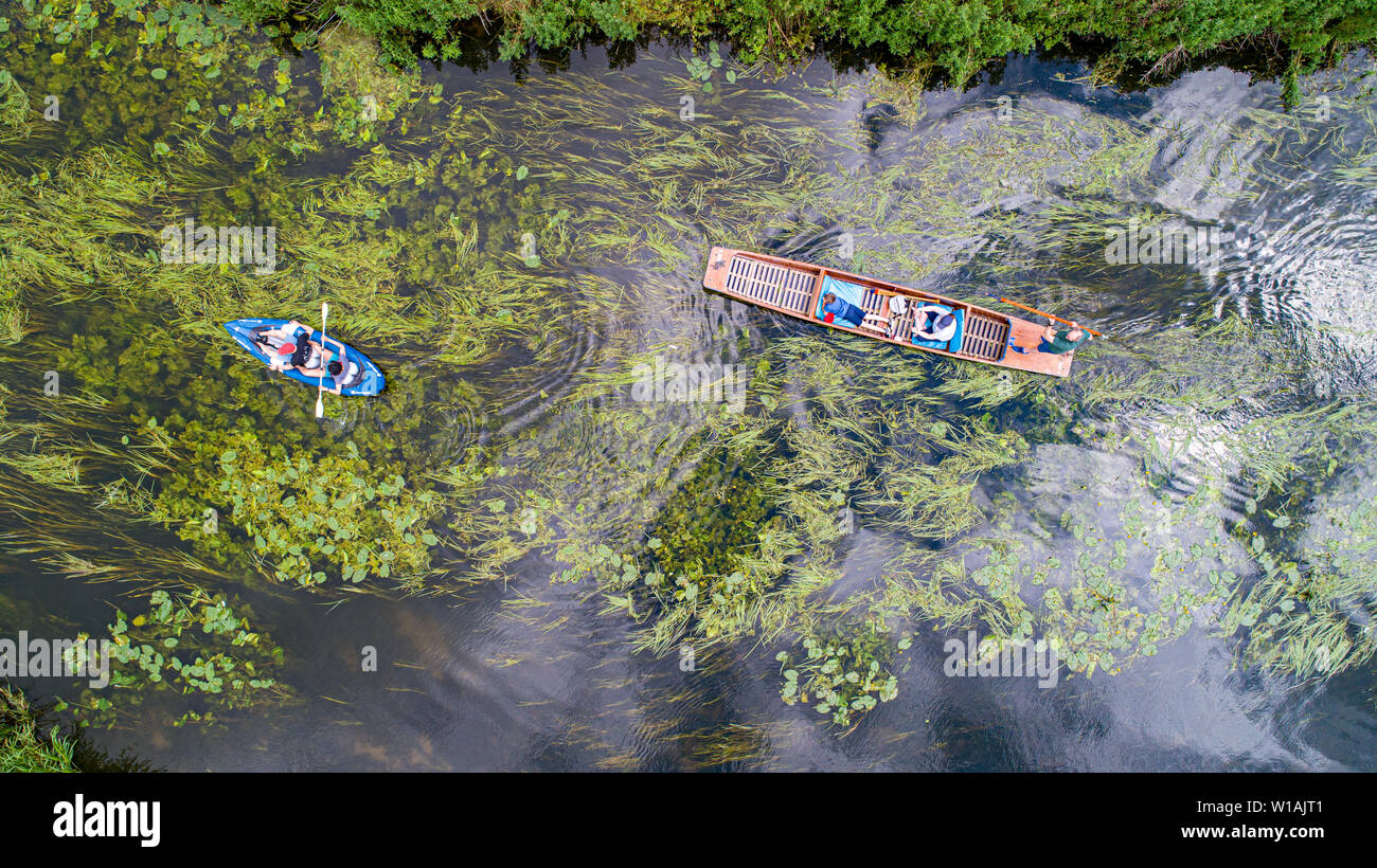 Aerial picture dated June 30th shows a punt and canoe  on the River Cam by Grantchester Meadows,Cambridgeshire, on Sunday afternoon as people make  the most of the good weather. Cooler weather is forecast for later in the week.  The Met Office forecast for today states rather cloudy across Scotland and Northern Ireland with some rain or heavy showers. Elsewhere, largely dry with sunny spells, although rather cloudy initially in the west. Feeling fresher for all, but still warm in any sunshine in the south.  Tonight:  Dry with clear spells overnight across the south and east. Rather cloudy else Stock Photo