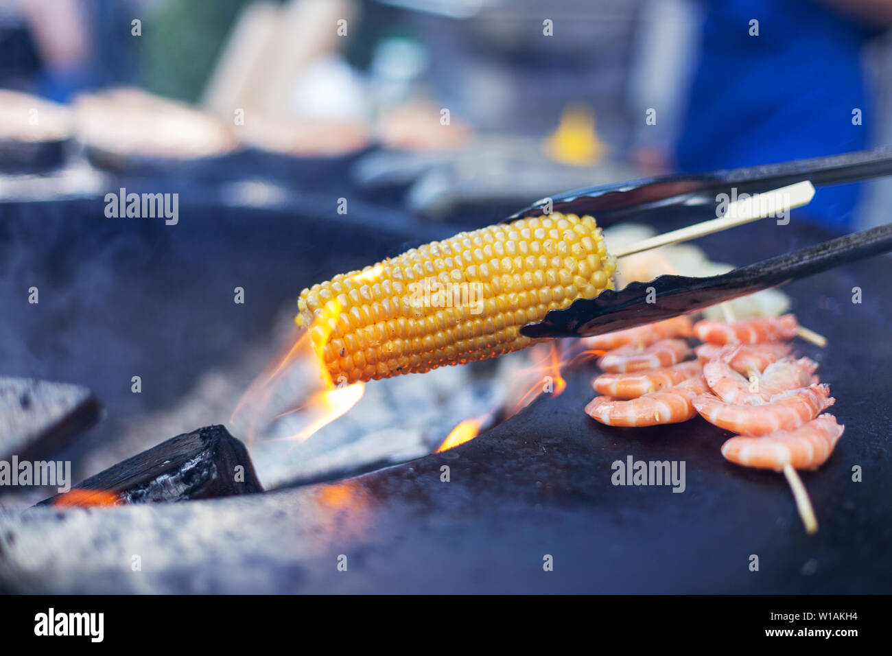 Corn cob on open fire. Concept of street food Stock Photo