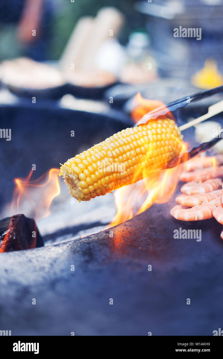 Corn cob on open fire. Concept of street food Stock Photo