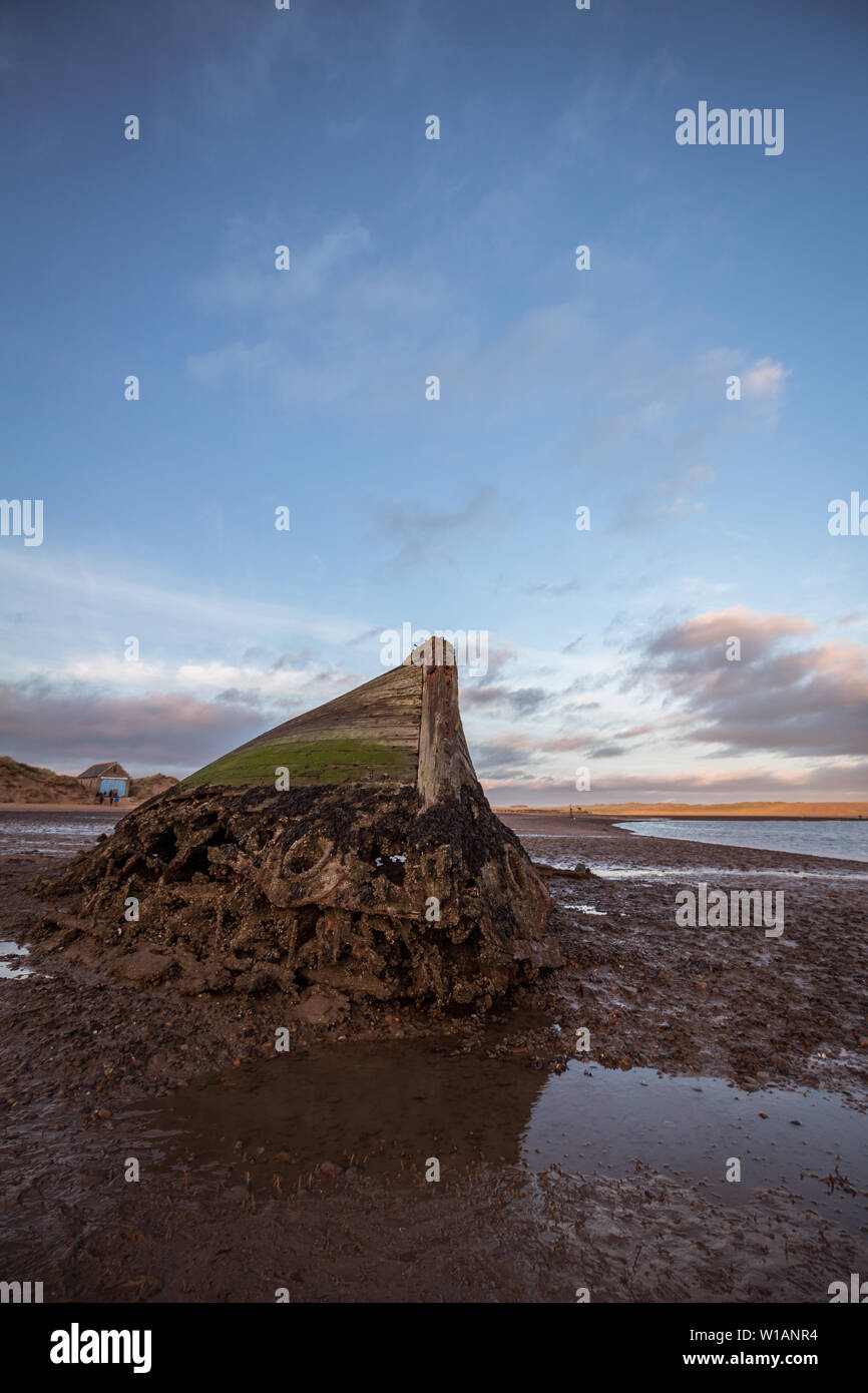 Image of the shipwreck at low tide in the Ythan Estuary, Newburgh, Aberdeenshire, Scotland, UK. Taken as the sun was setting. Stock Photo