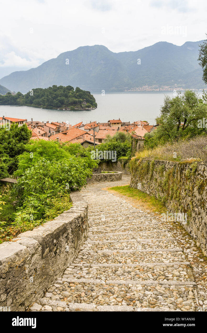 LAKE COMO, ITALY - JUNE 2019: Stone steps on the route of a walking trail along part of Lake Come - the Greenway del Lago di Como. Stock Photo
