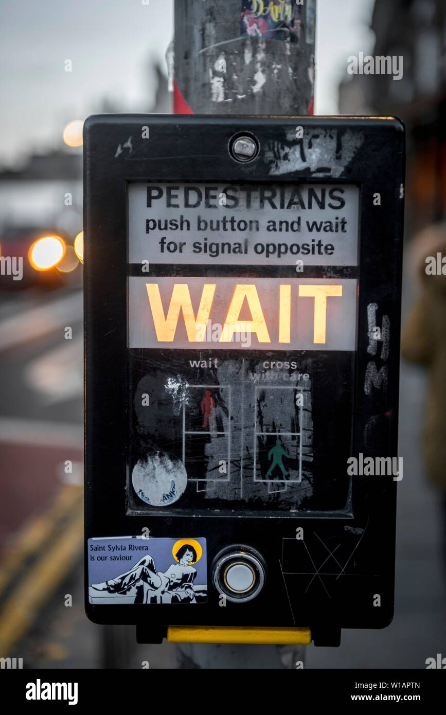 WAIT, waiting at traffic lights for green signal for pedestrians