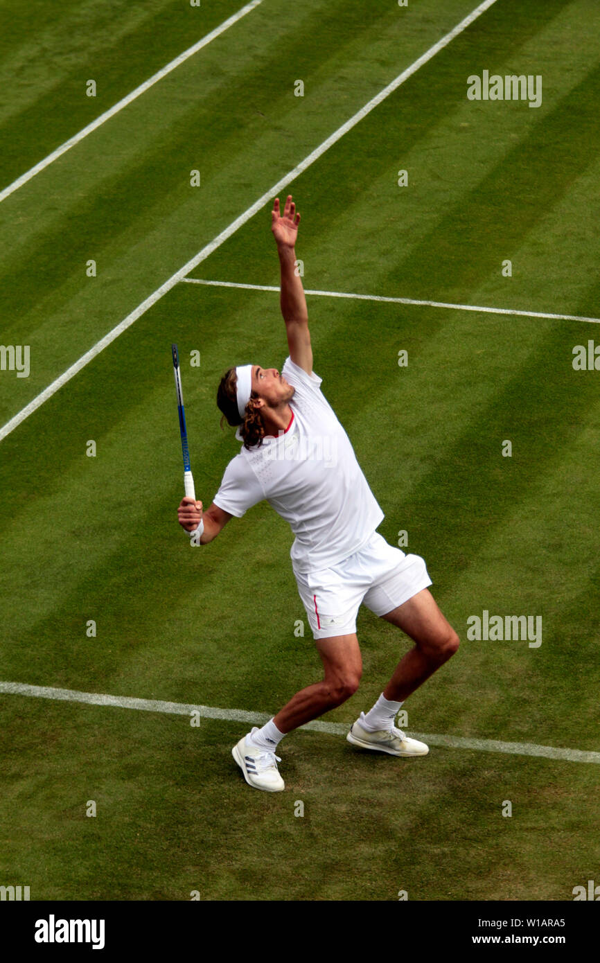 Wimbledon, 1 July 2019 - Stefanos Tsitsipas of Greece serving during his  first round match against Thomas Fabbiano of Italy in opening day action at  Wimbledon. Fabiano upset Tsitsipas to advance to