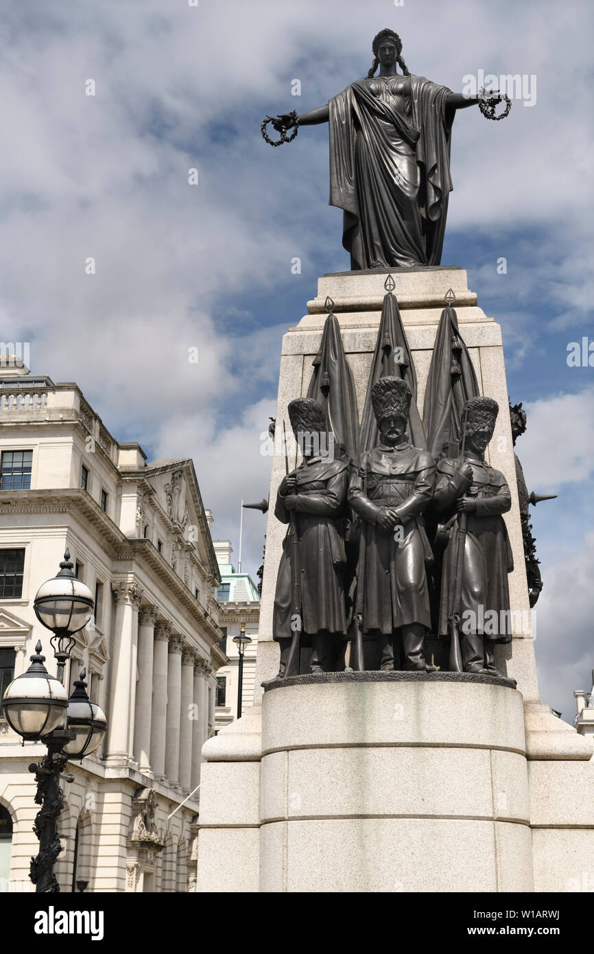 Crimean War Memorial at Waterloo Place with bronze sculpture of three Guardsmen and female symbol of honour and victory London England Stock Photo