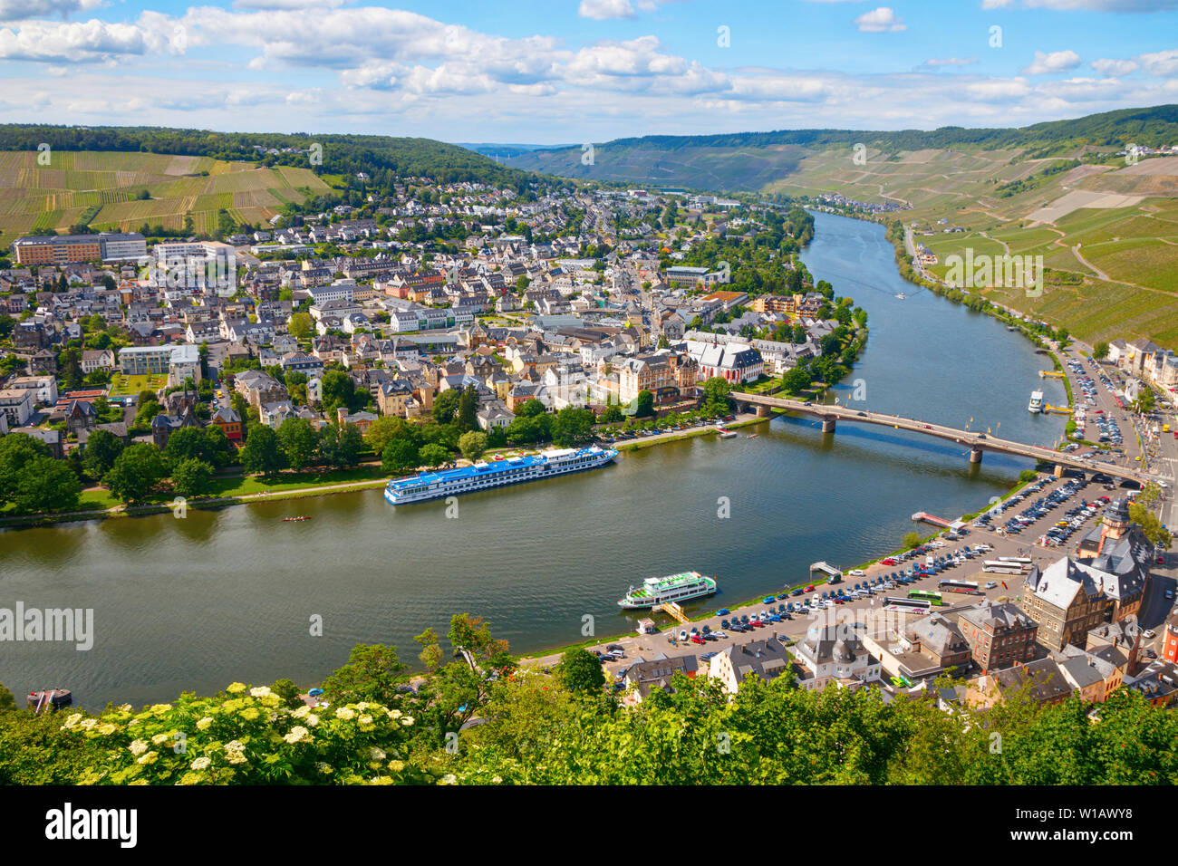 BERNKASTEL-KUES, RHINELAND-PALATINATE, GERMANY – MAY 31, 2019: Aerial view of the western side of the town, the Moselle river and the surrounding vine Stock Photo