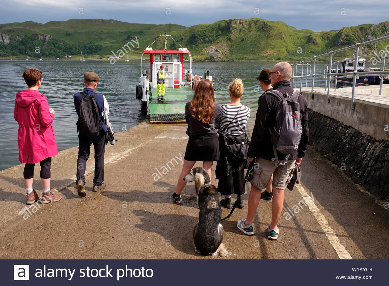People on the Island of Kerrera boarding the Caledonian MacBrayne ferry Carvoria, to be ferried across the Sound of Kerrera to the Scottish mainland Stock Photo
