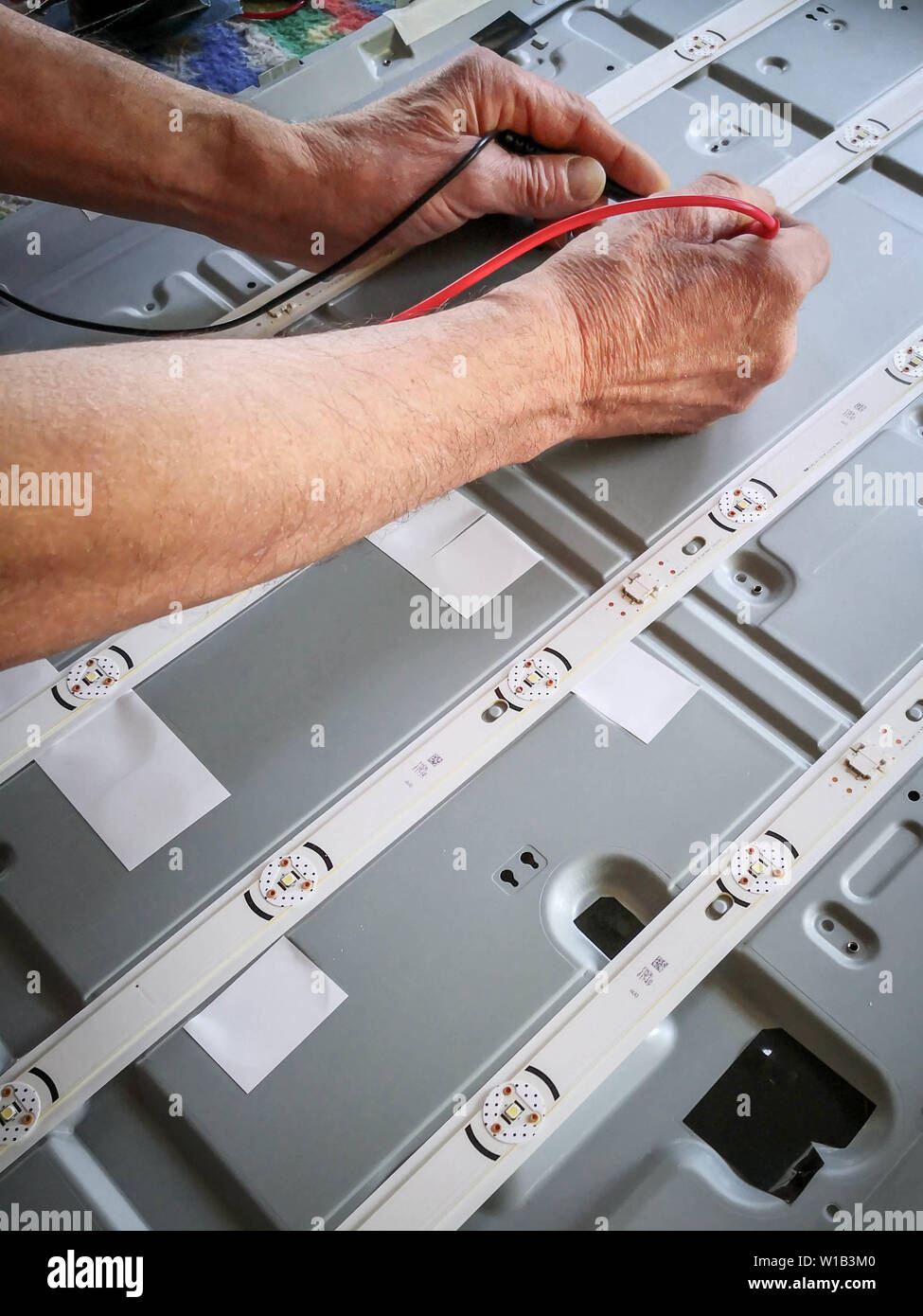 Engineer testing electronic component with voltage meter Stock Photo