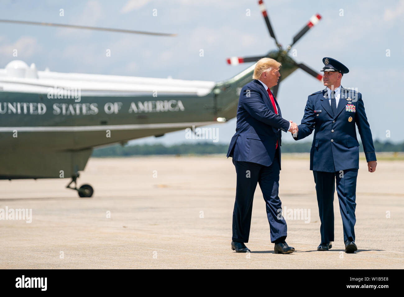 Washington, United States Of America. 26th June, 2019. President Donald J. Trump disembarks Marine One and is escorted by United States Air Force Col. Samuel J. Chesnut, Vice Commander of the 89th Airlift Wing, at Joint Base Andrews, Md. Wednesday, June 26, 2019, as they walk from Marine One to board Air Force One for his trip to Japan People: President Donald Trump Credit: Storms Media Group/Alamy Live News Stock Photo