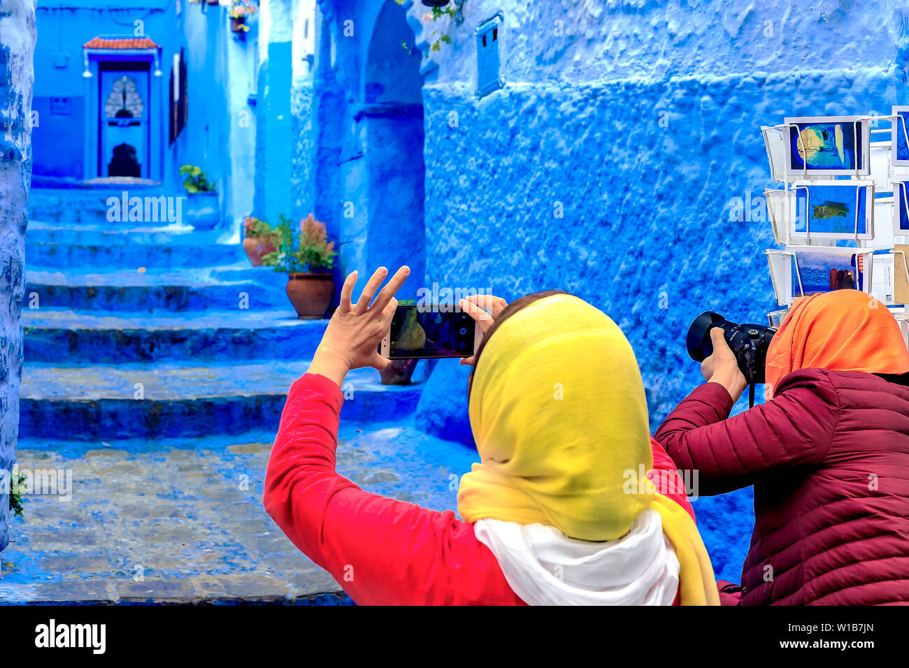Chefchaouen, Morocco - 24/04/2019: Tourists taking pictures in Chefchaouen, a beautiful city in northern Morocco visited by tourists from around the w Stock Photo