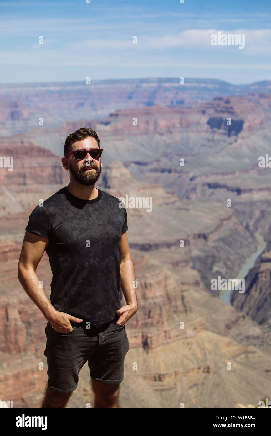 Fitted male middle age caucasian tourist with shades looking at the camera in South Rim, Grand Canyon National Park, Arizona, USA Stock Photo