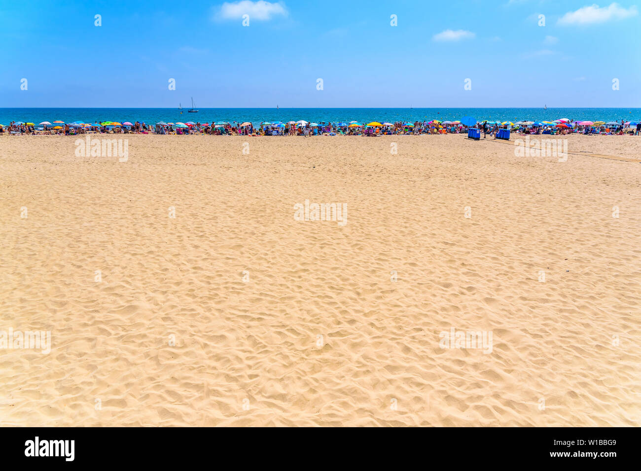 Valencia, Spain June 23, 2019 Bathers with their beach umbrellas on