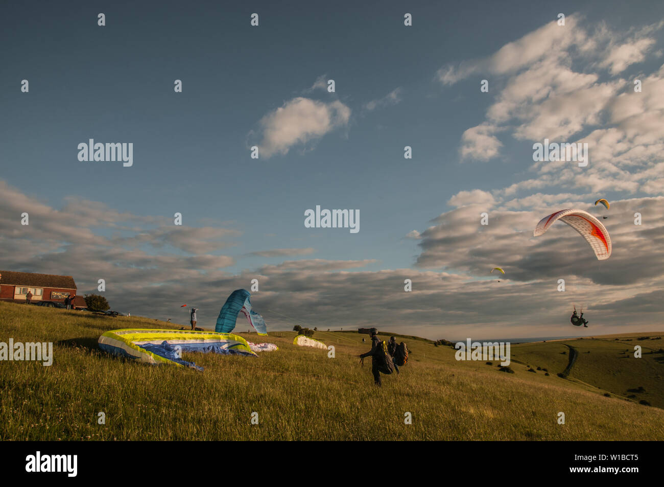 Devils Dyke, Brighton, East Sussex, UK..1st July 2019..Wind from the NNE brings paraglider pilots to the picturesque site in the South Downs North of Brighton. . Stock Photo