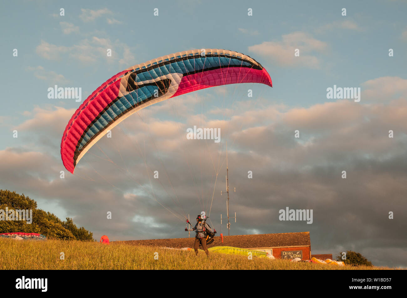 Devils Dyke, Brighton, East Sussex, UK..1st July 2019..Wind from the NNE brings paraglider pilots to the picturesque site in the South Downs North of Brighton. . Stock Photo