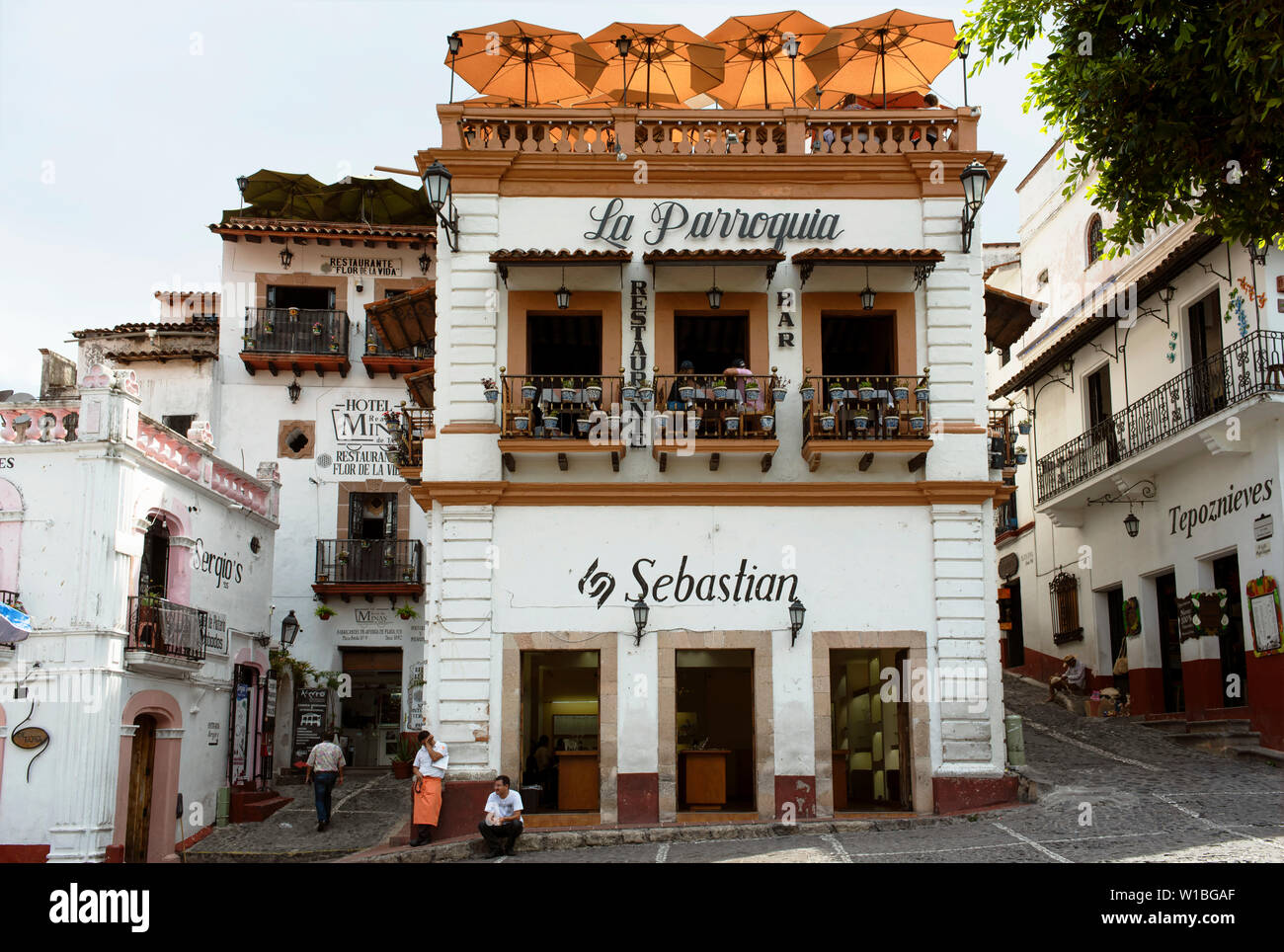 Street view at the Zocalo (main square) in the historical centre of Taxco, Guerrero State, Mexico. Colonial building with restaurant and a silver shop Stock Photo