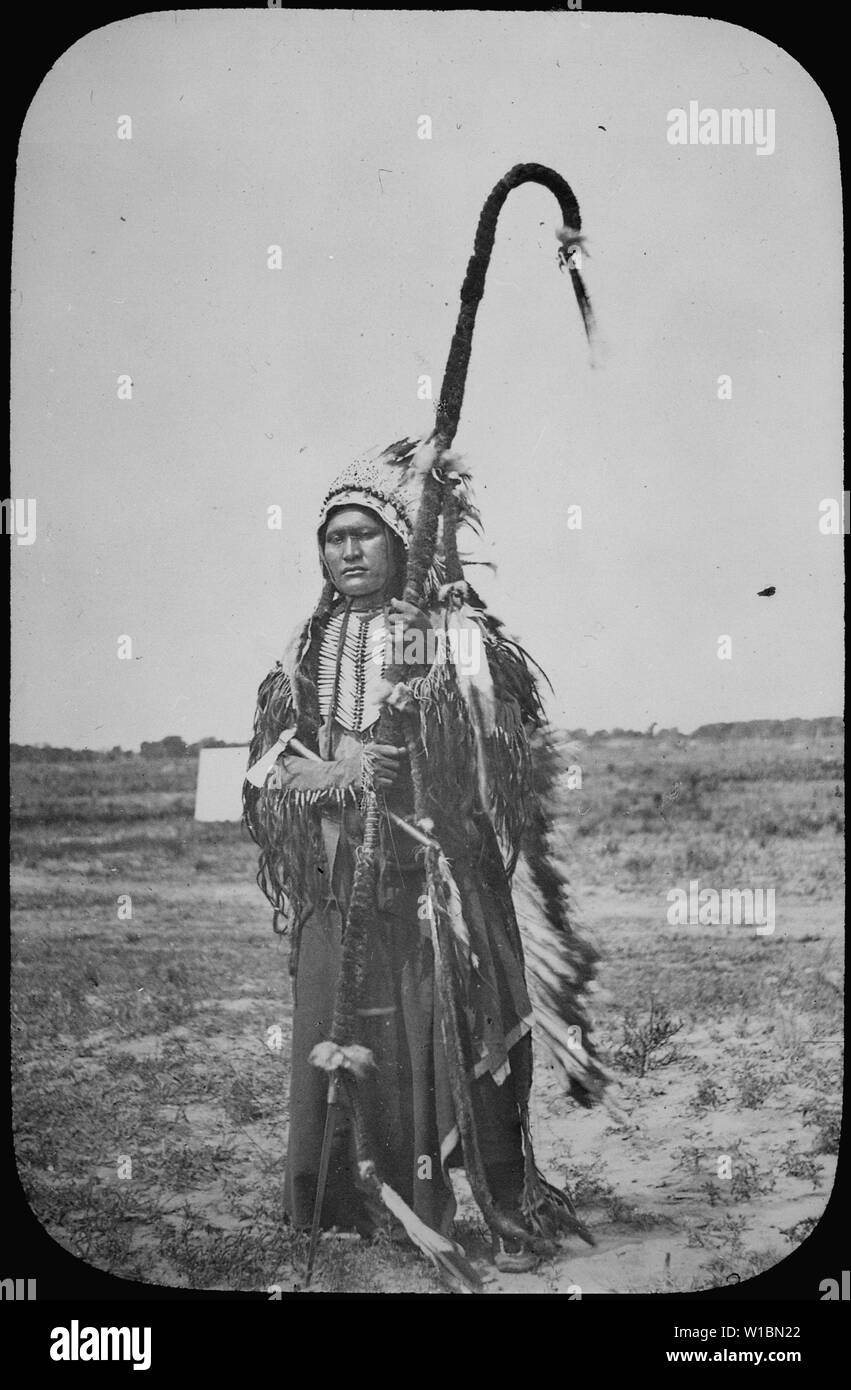 Chief Powder Face of the Arapaho; standing full-length, wearing war costume, 1864 Stock Photo