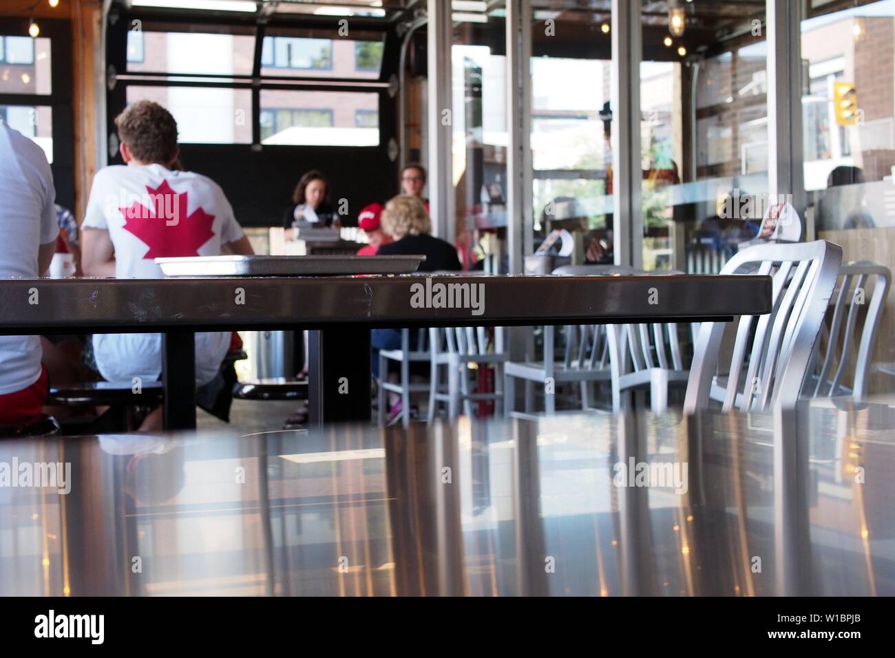 Before heading downtown, Canada day revelers stop off for a bagel at