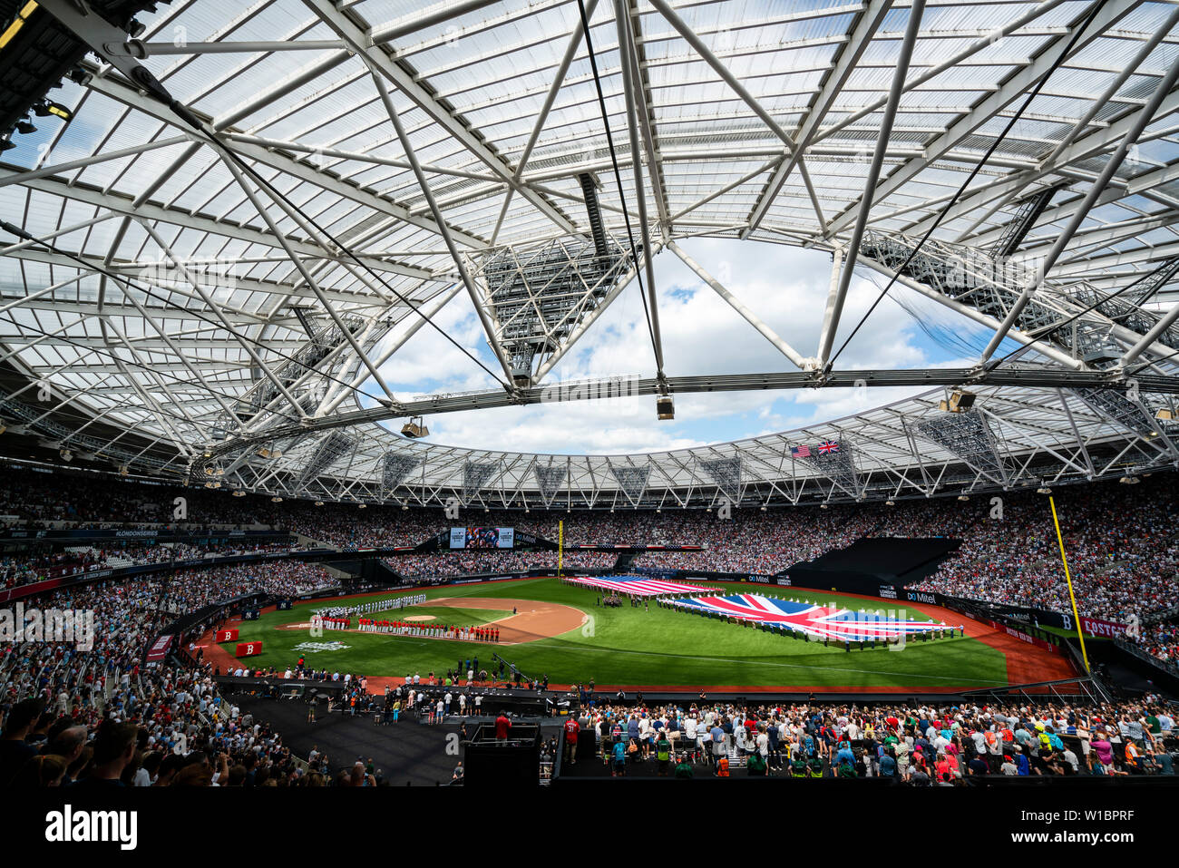 U.S. Airmen present the colors of the American flag next to their Royal military partners during game two of the Major League Baseball London Series at London Stadium June 30, 2019. The game featured two of MLB's oldest teams, the New York Yankees and the Boston Red Sox in front of a sold-out venue of 60,000 fans. (U.S. Air Force photo by SSgt Rachel Maxwell) Stock Photo