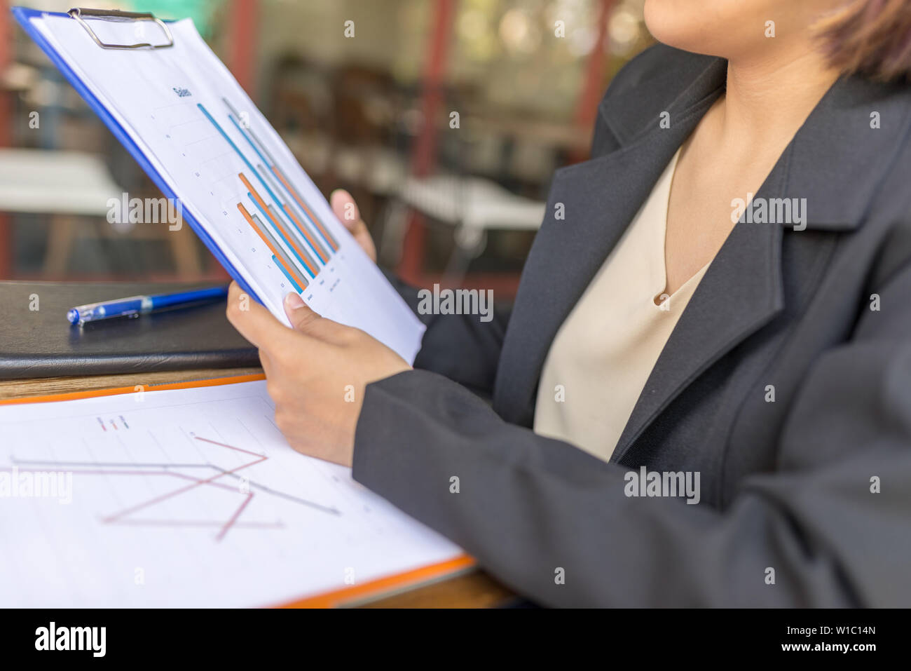 Close up photo of woman holding sales report chart folder Stock Photo ...