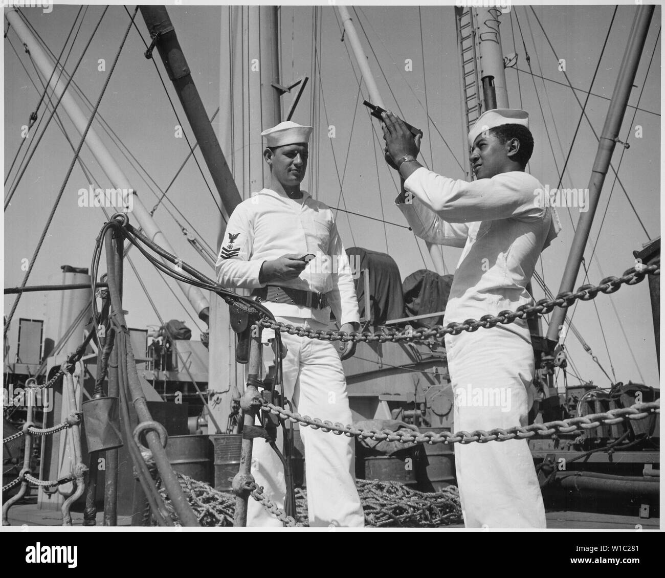 Coxswain William Green observes safety precautions in checking his