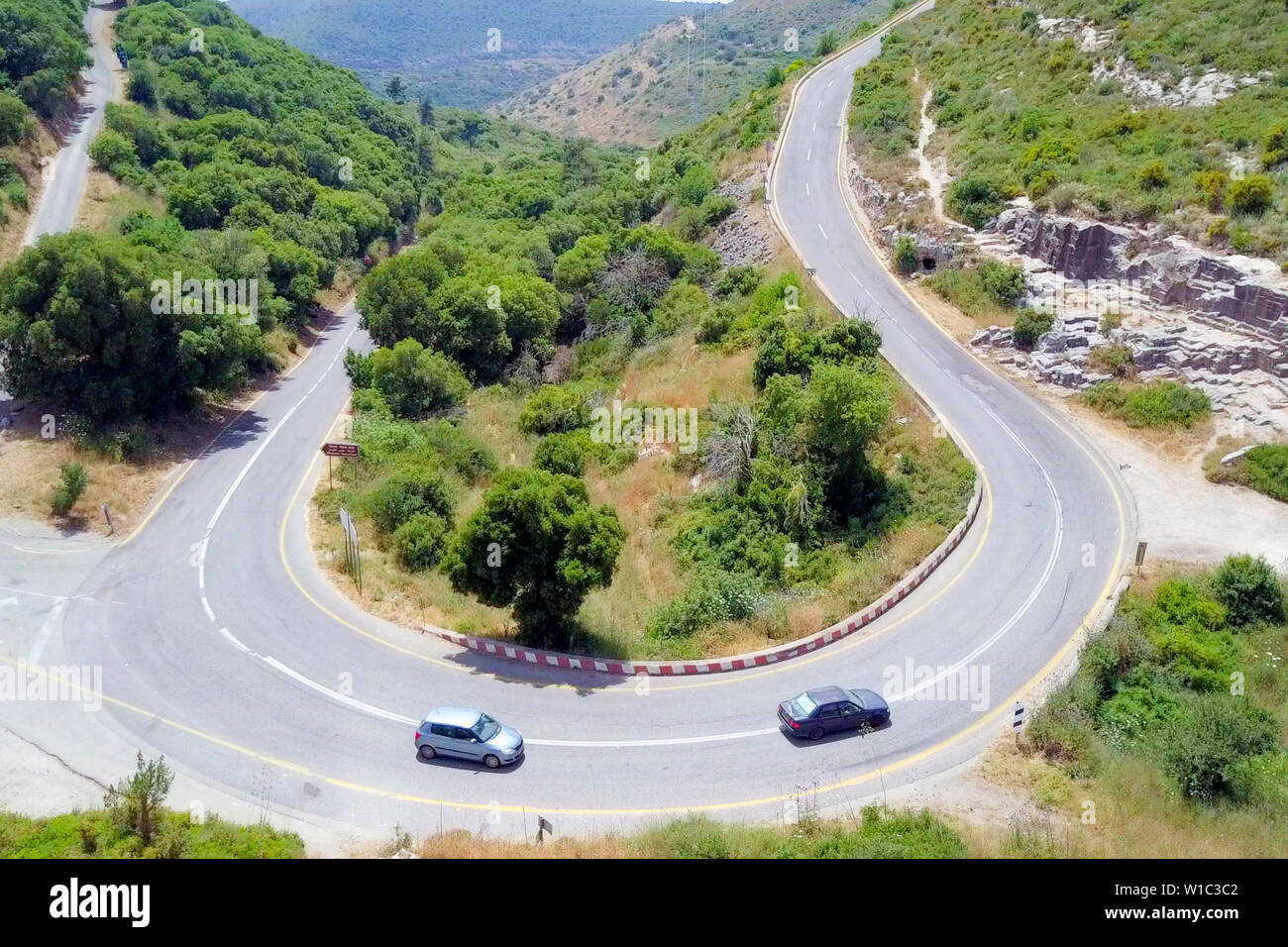 Aerial image of a mountain road with traffic on a Horseshoe curve. Stock Photo