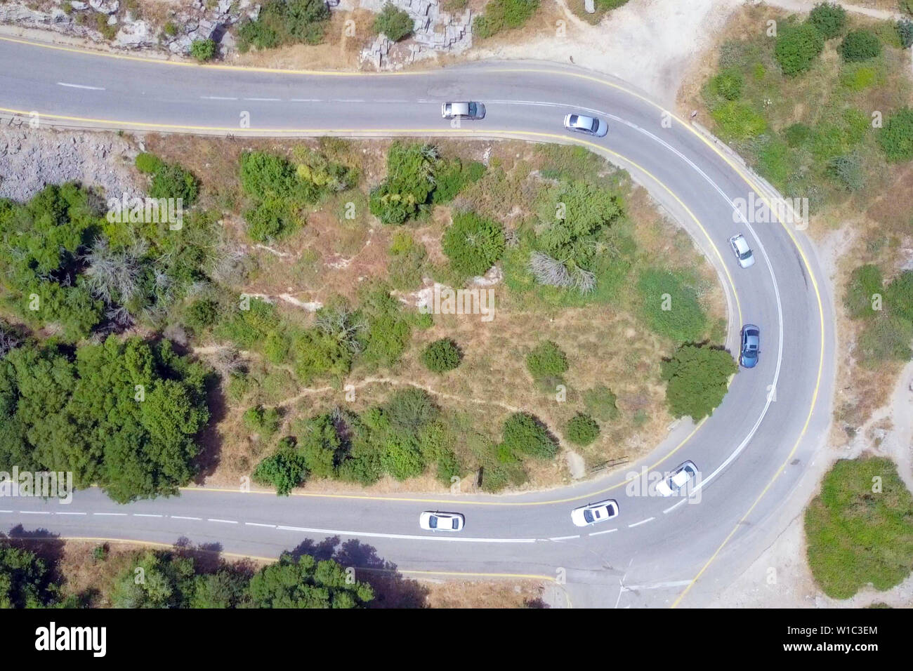 Aerial image of a mountain road with traffic on a Horseshoe curve. Stock Photo