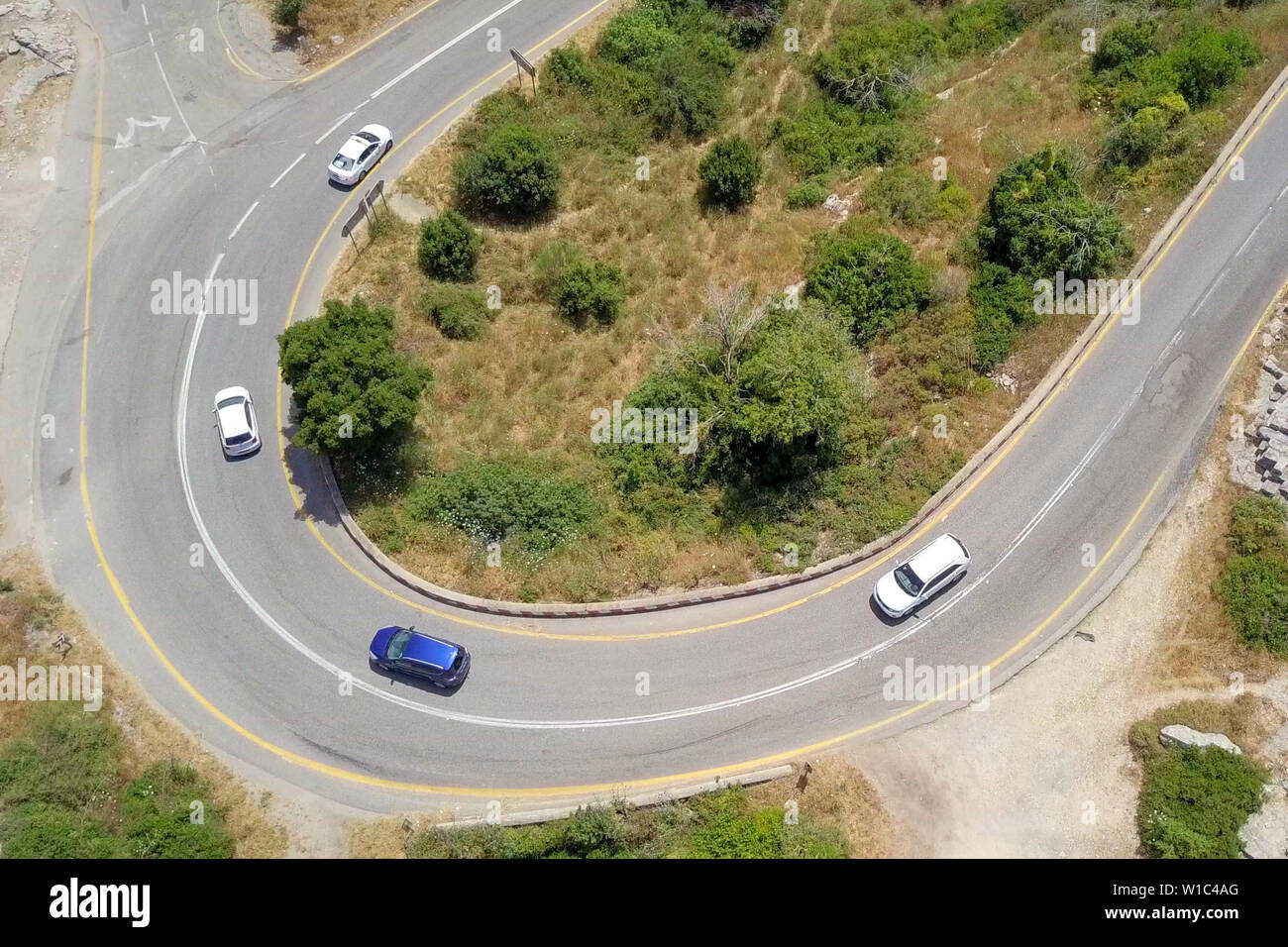 Aerial image of a mountain road with traffic on a Horseshoe curve. Stock Photo