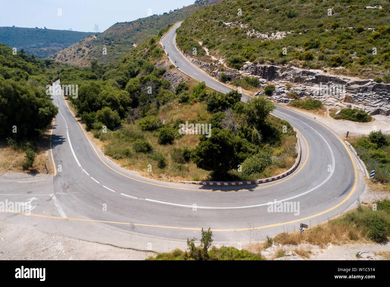 Traffic on a Serpentine mountain road, Aerial image. Stock Photo