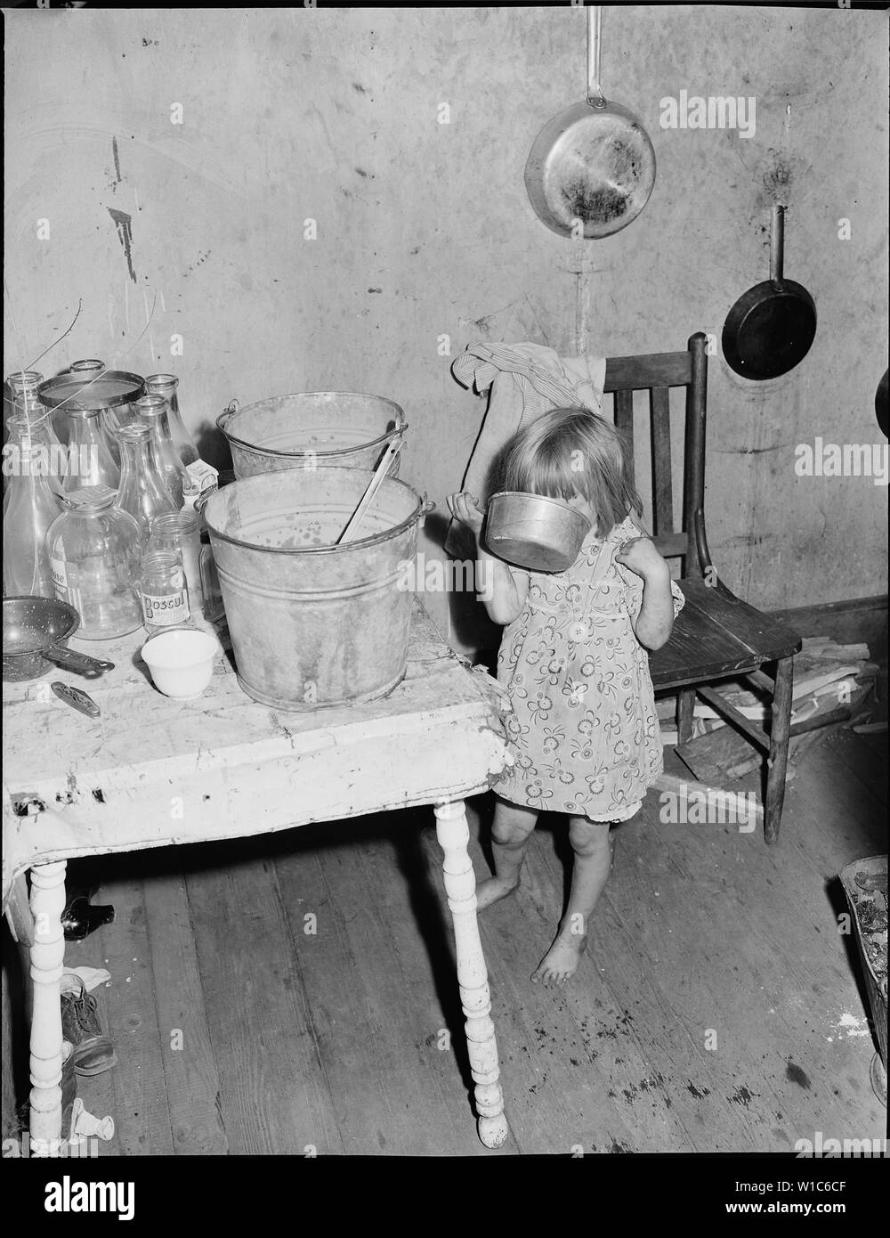 Daughter of Bill Daniels, drinking water. This water was red and thick