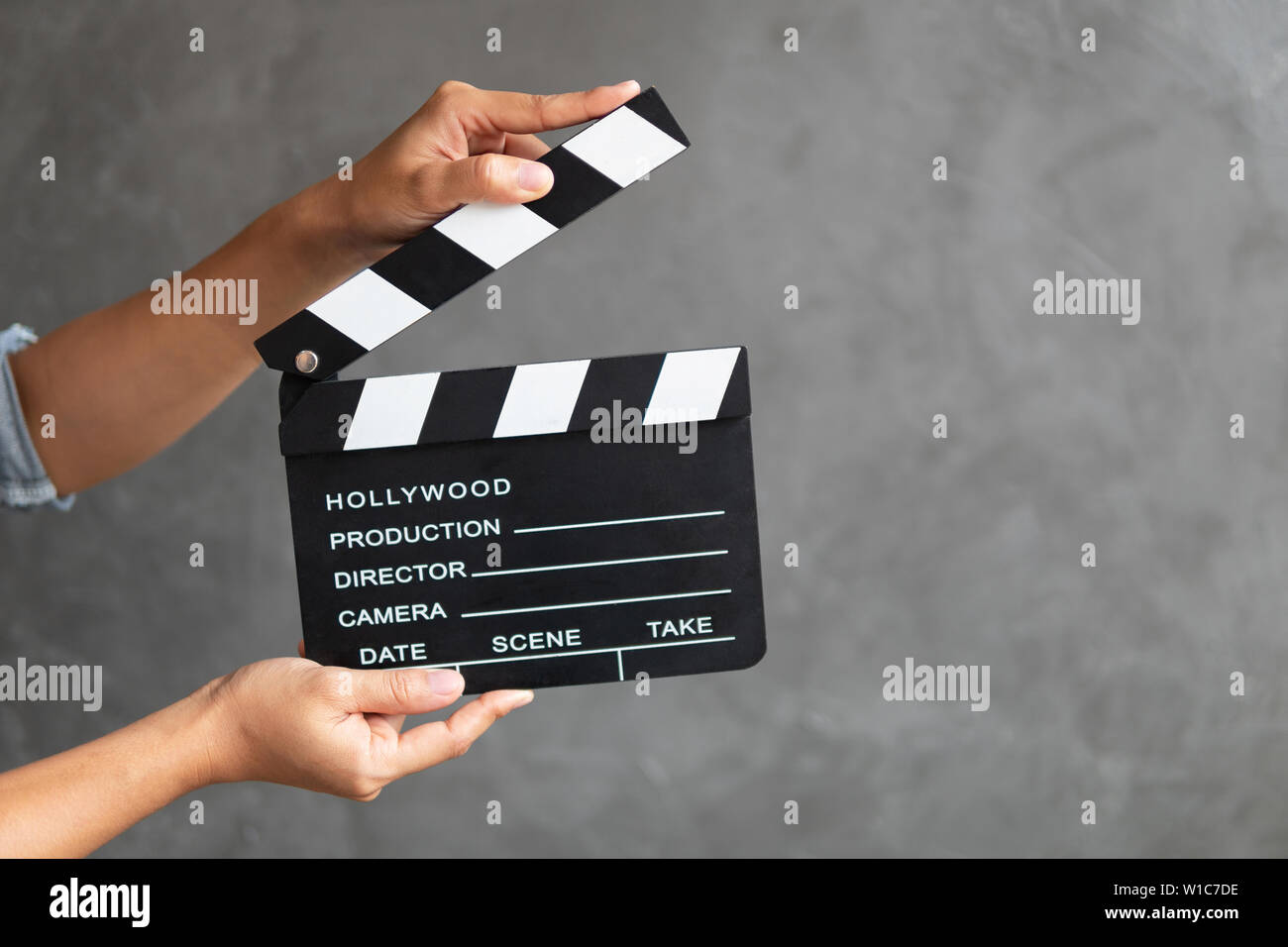 Women hands holding clapper board for making video cinema in studio. Stock Photo