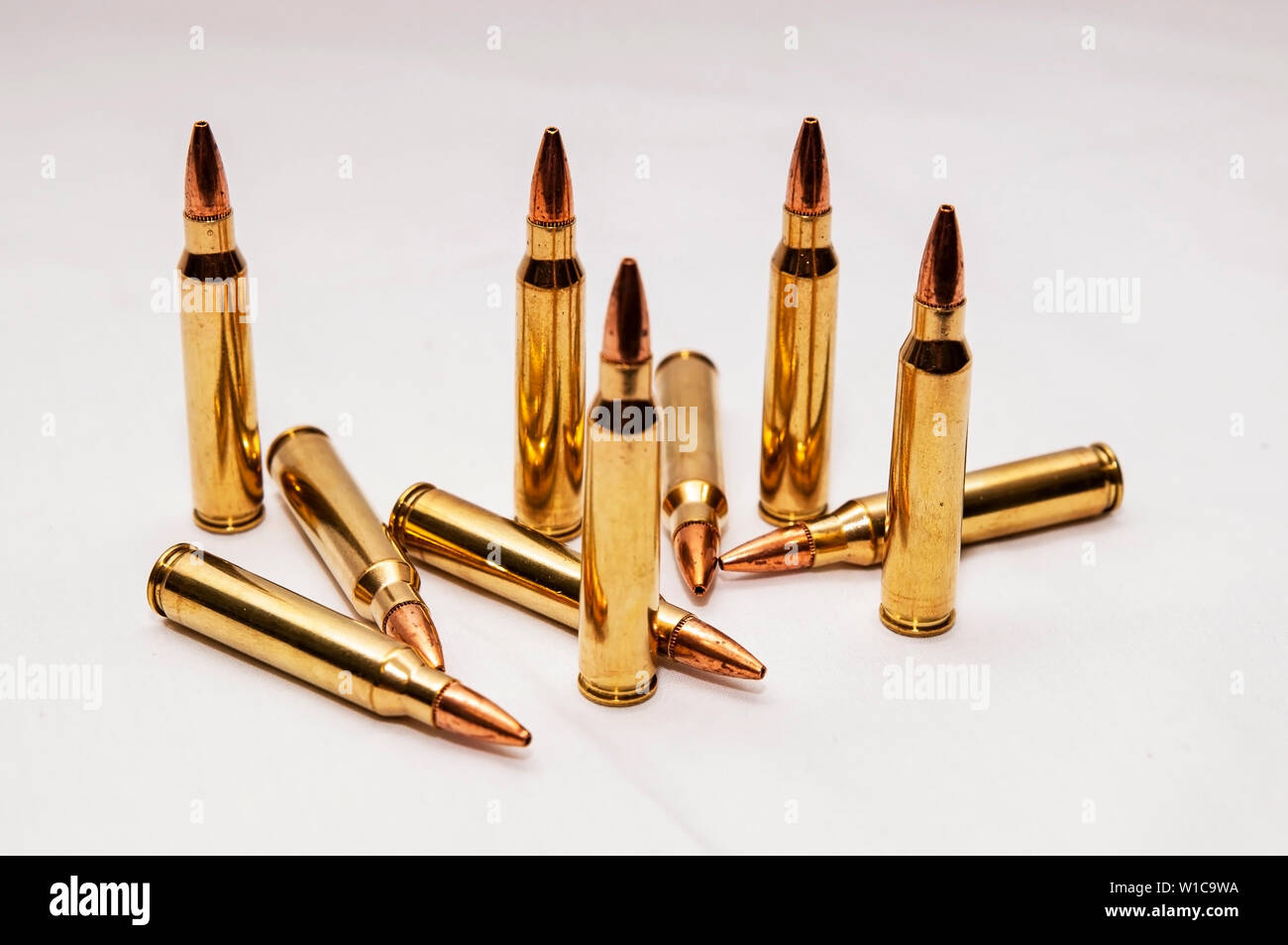 Ten 223 caliber bullets on a white background Stock Photo