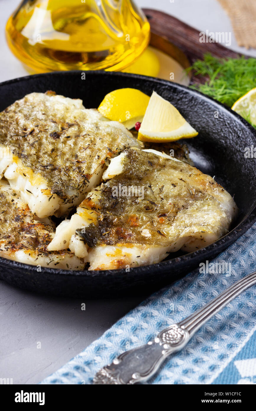 Fried cod fish fillet with spice in a cast iron pan Stock Photo Alamy