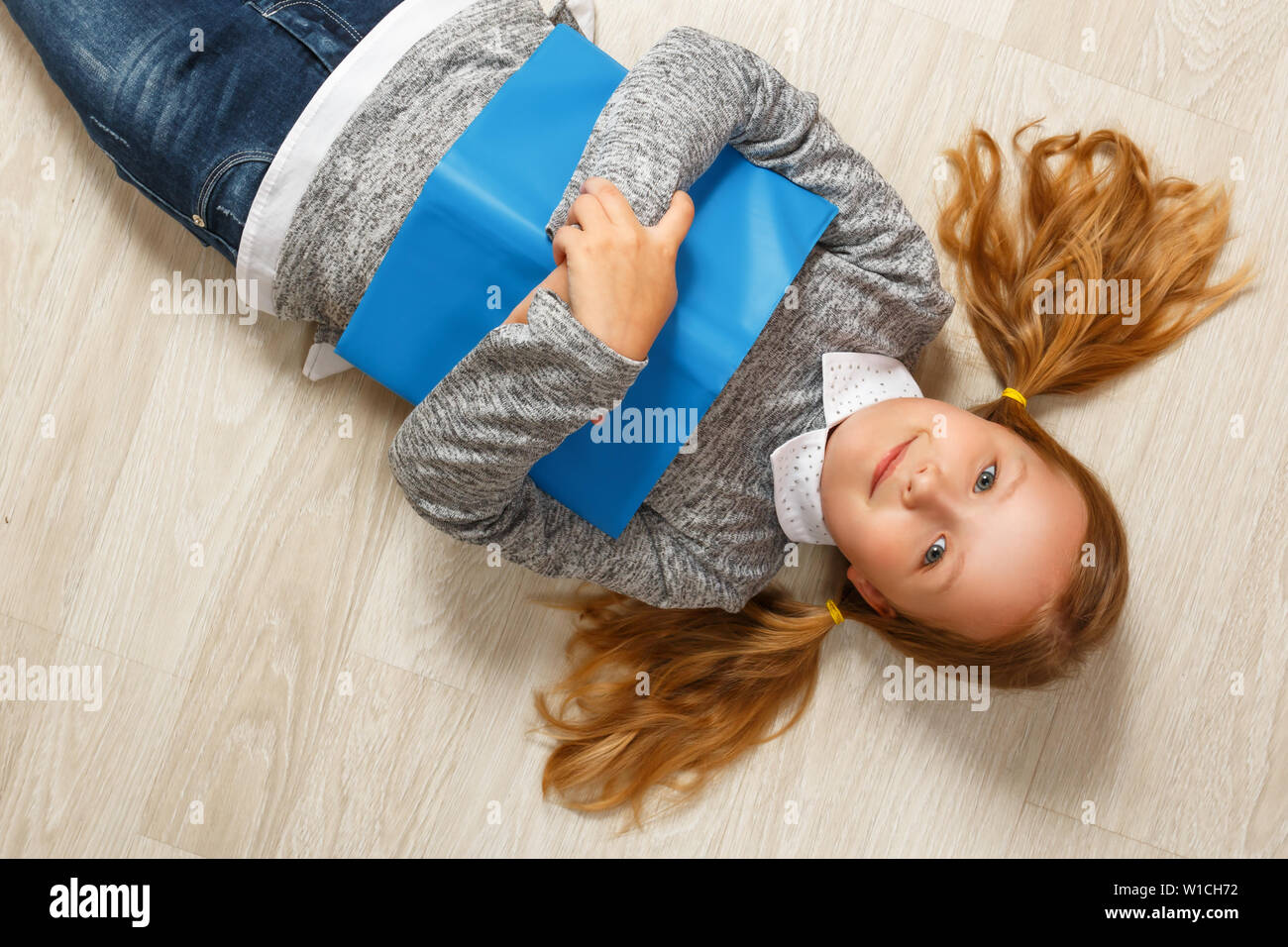 Little girl lying on the floor on her back hires stock photography and images Alamy
