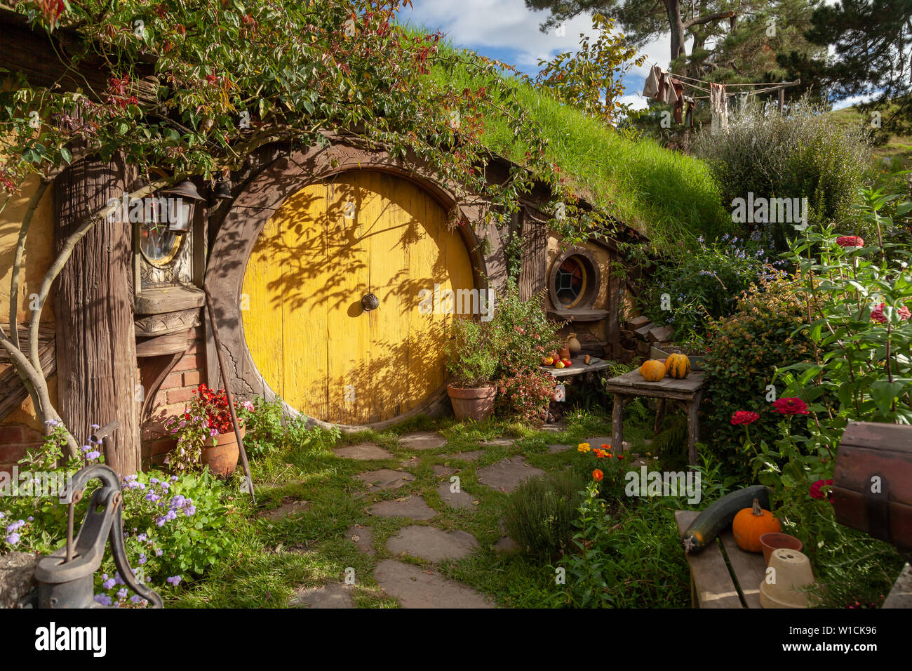 Hobbit House of Samwise Gamgee in Hobbiton the Shire illuminated by the sun about to set over the shire. Stock Photo