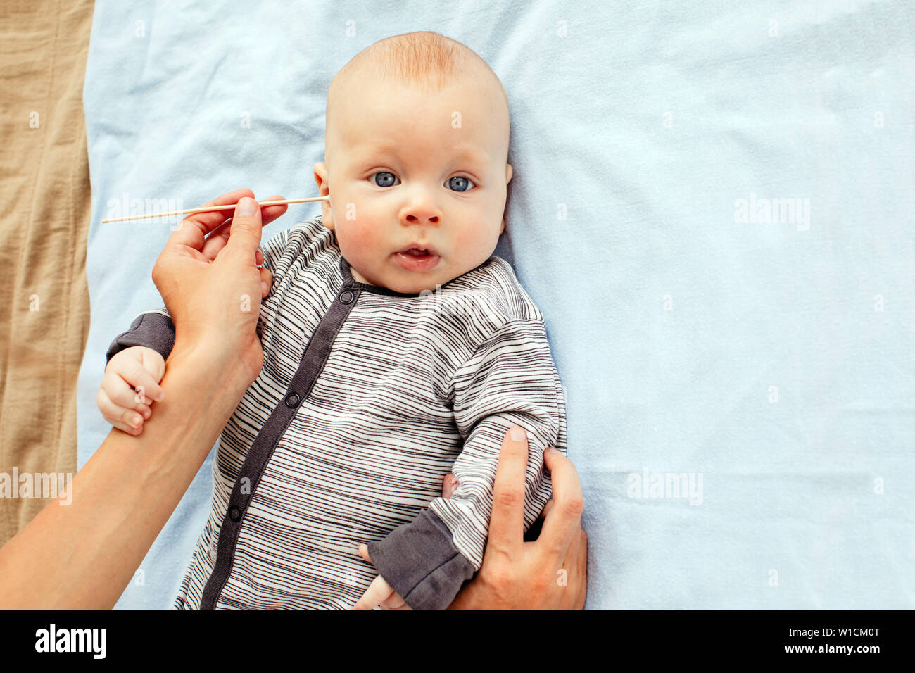 Baby boy cleaning ear Stock Photo Alamy