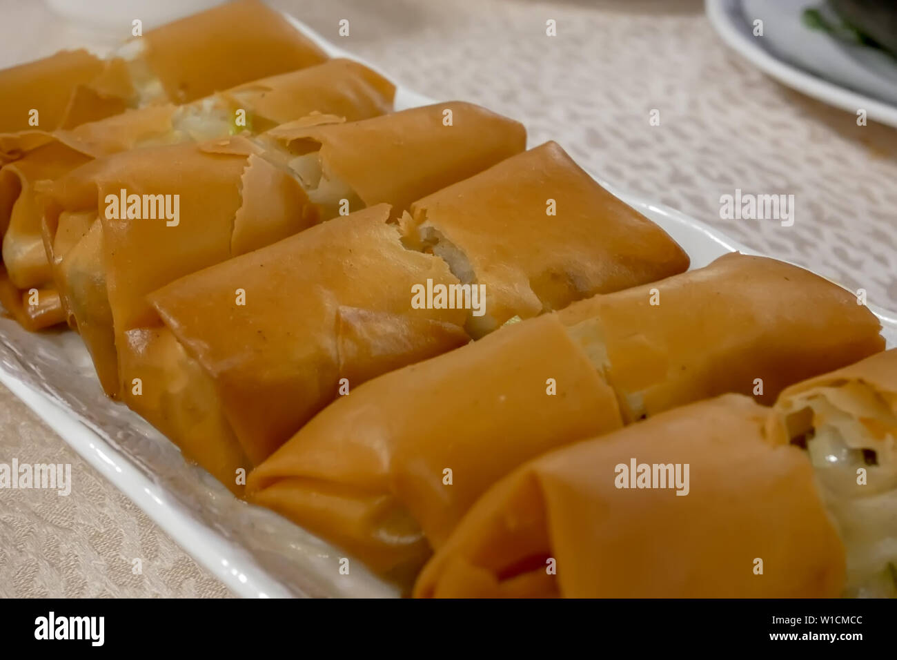 Close up of spring roll appetizers on table inside Chinese restaurant Stock Photo