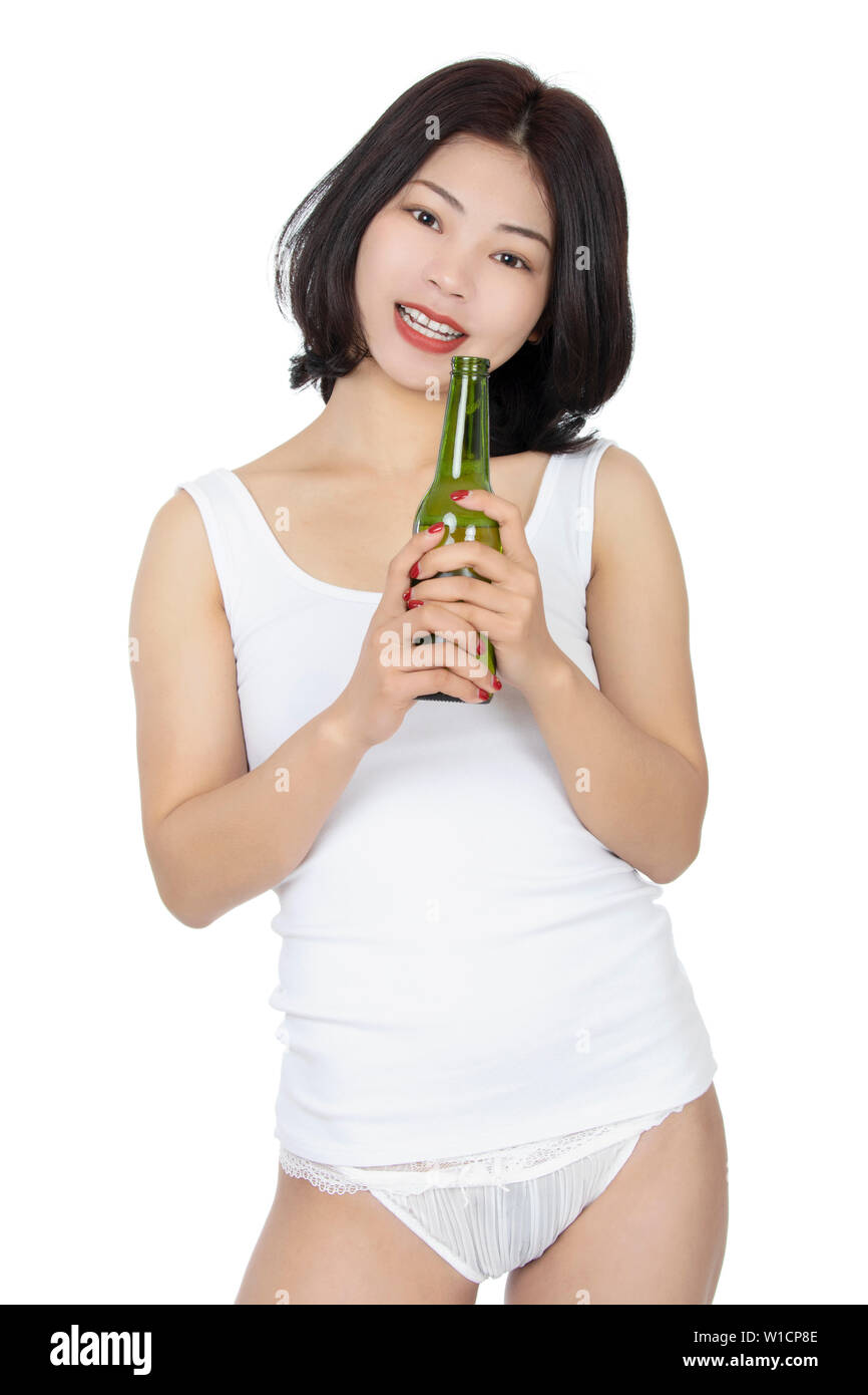 Free Shipping on All Orders A Young Girl, in a Bra and a Sleeping Mask,  Holds a Bottle of Alcohol and Looks at it. on a Red Background. Stock Photo  - Image