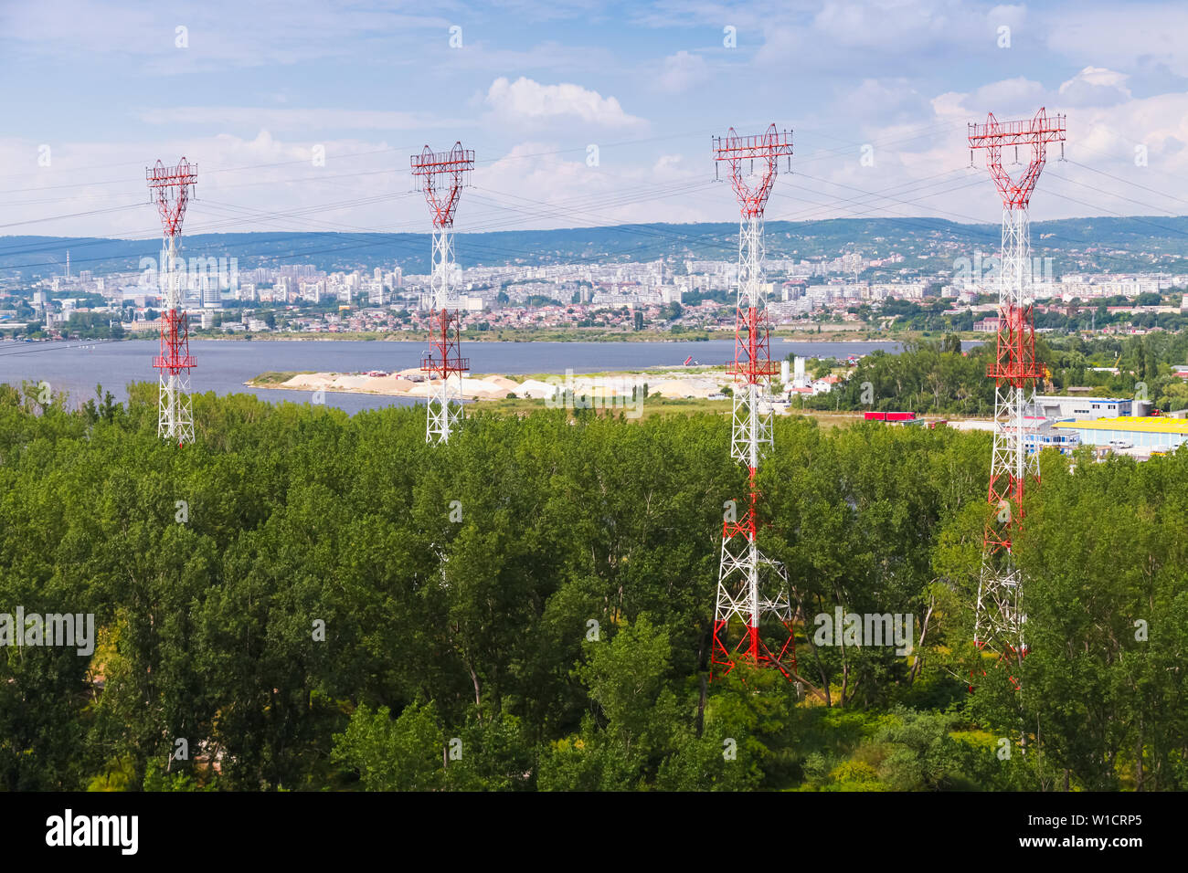 High-voltage power line. Red white truss poles. Photo taken from Asparuhov Bridge, Varna, Bulgaria Stock Photo