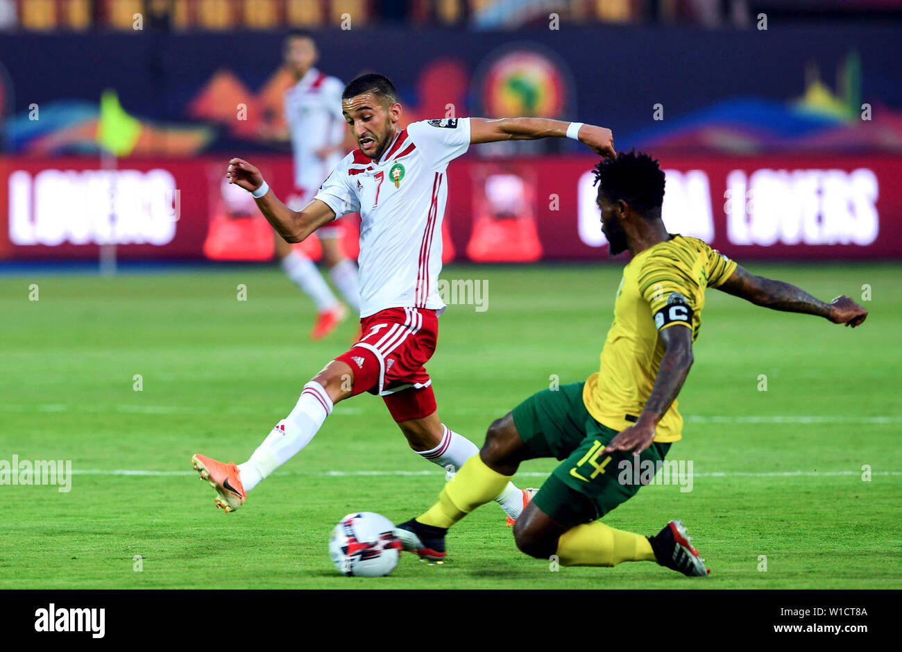 Cairo. 1st July, 2019. Hakim Ziyach of Morocco competes with Thulani Hlatshwayo (R) of South Africa during the 2019 Africa Cup of Nations Group D match between Morocco and South Africa in Cairo, Egypt on July 1, 2019. Credit: Li Yan/Xinhua/Alamy Live News Stock Photo