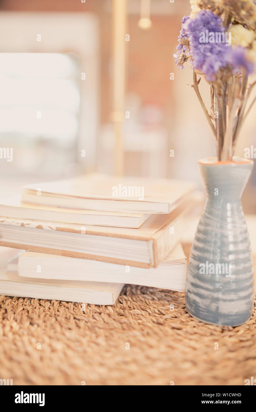 Close Up Books Stacking And Vase Dry Purple Flower On Table In