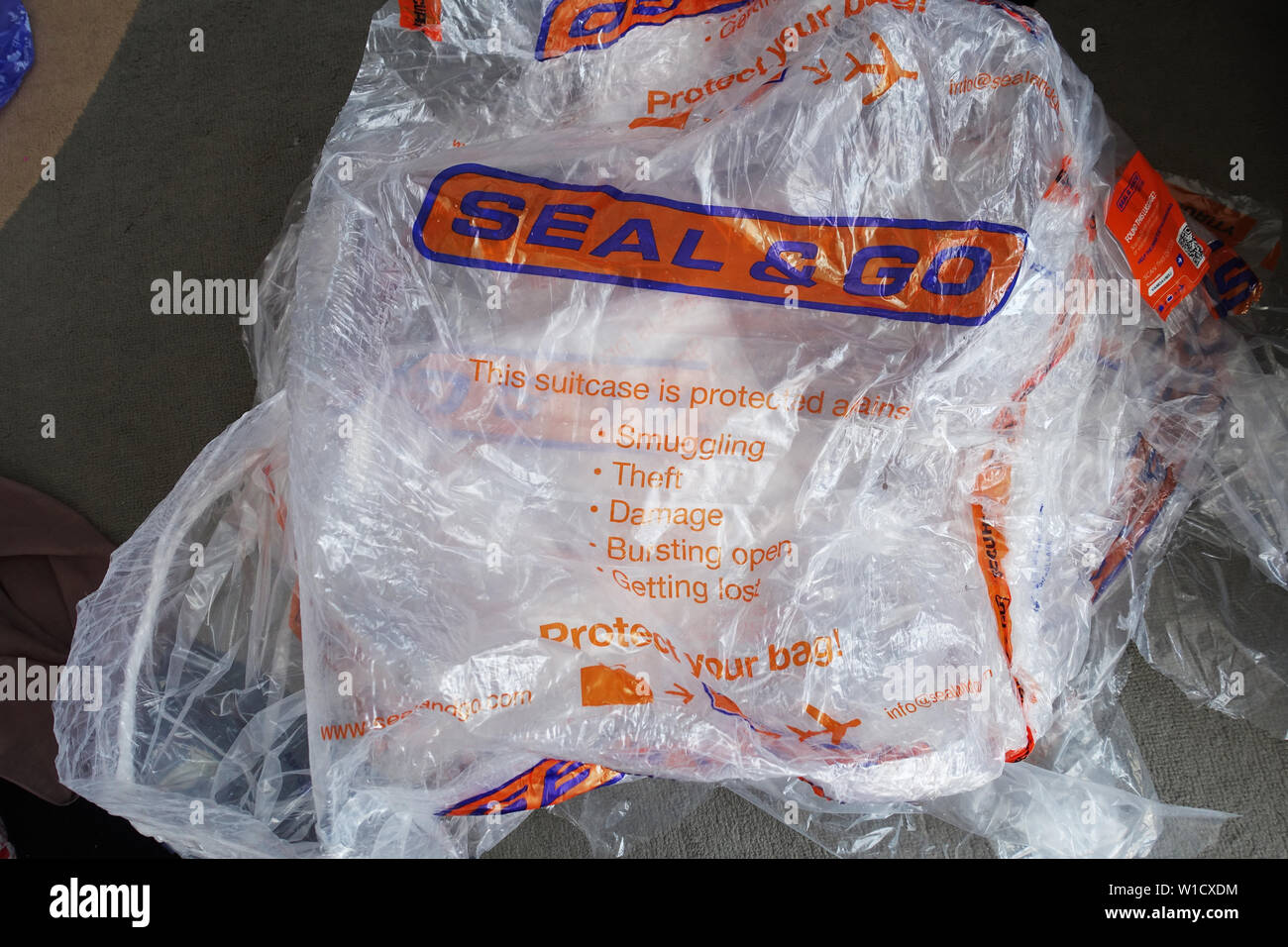 Seal and Go airline luggage wrapping Stock Photo