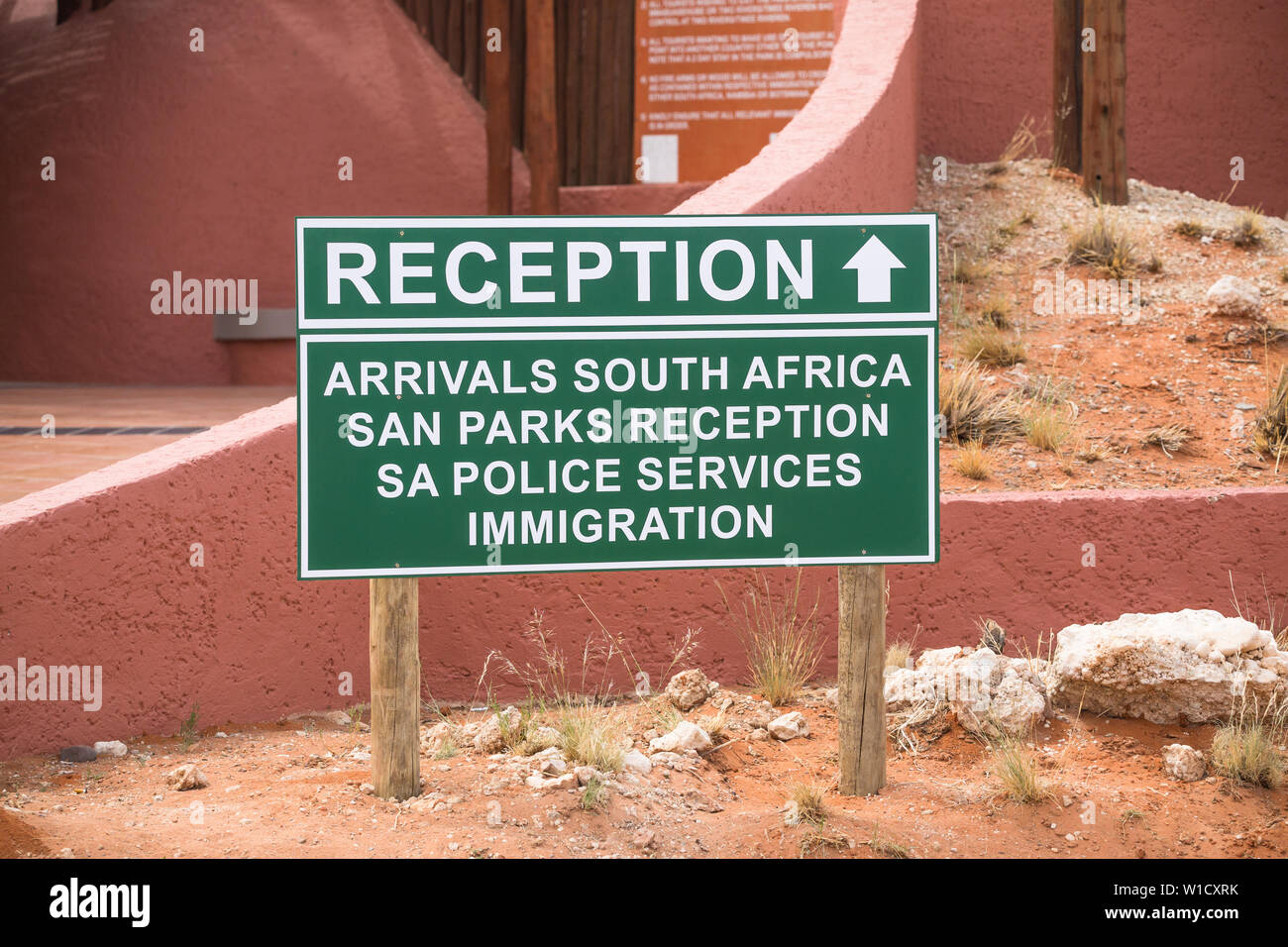 sign board with the words or text Reception arrivals South Africa San Parks reception S A police services immigration at Kgalagadi Transfrontier Park Stock Photo