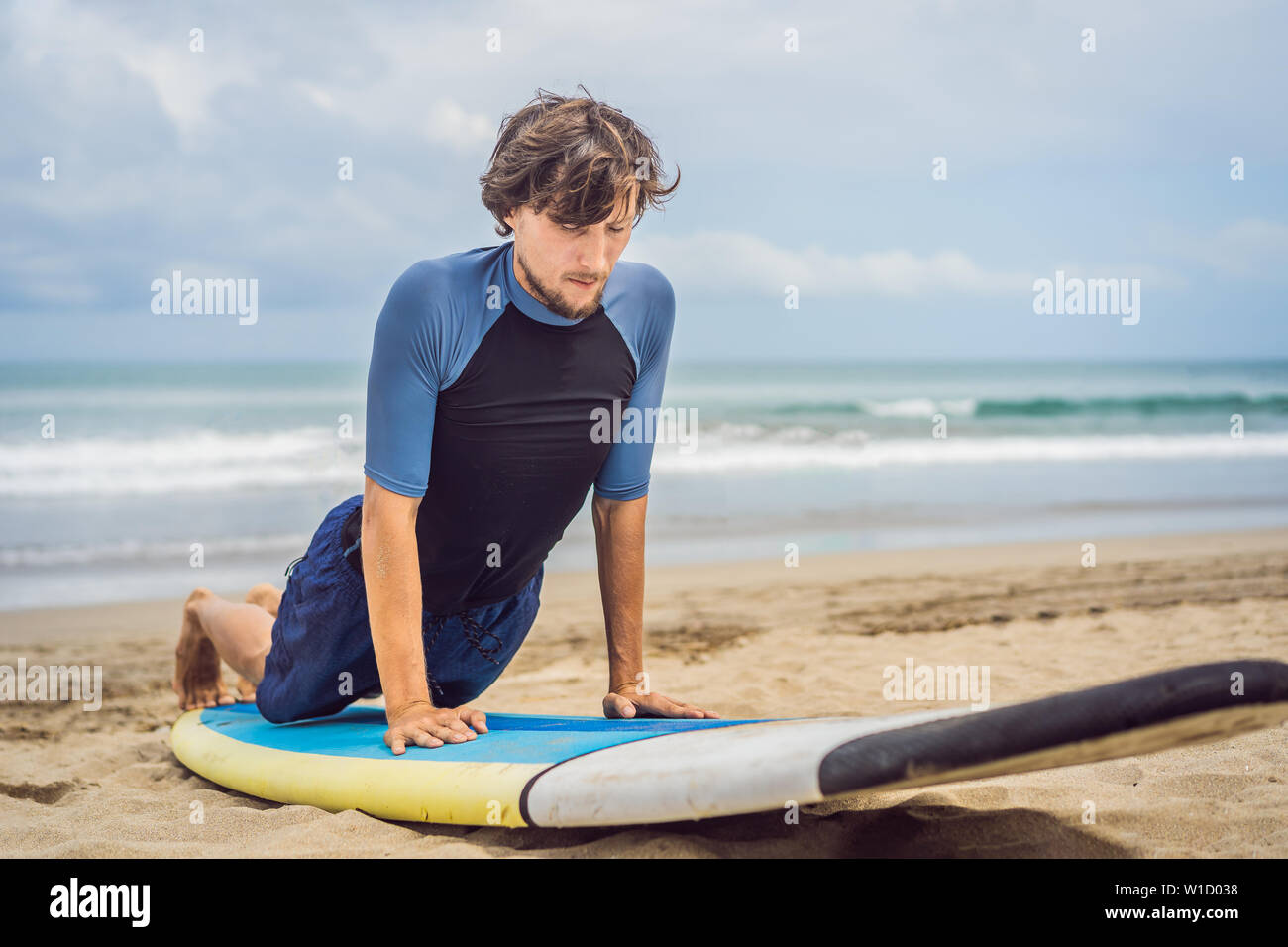 man surfer on the beach warming up before surfing, Surf Man in a wet