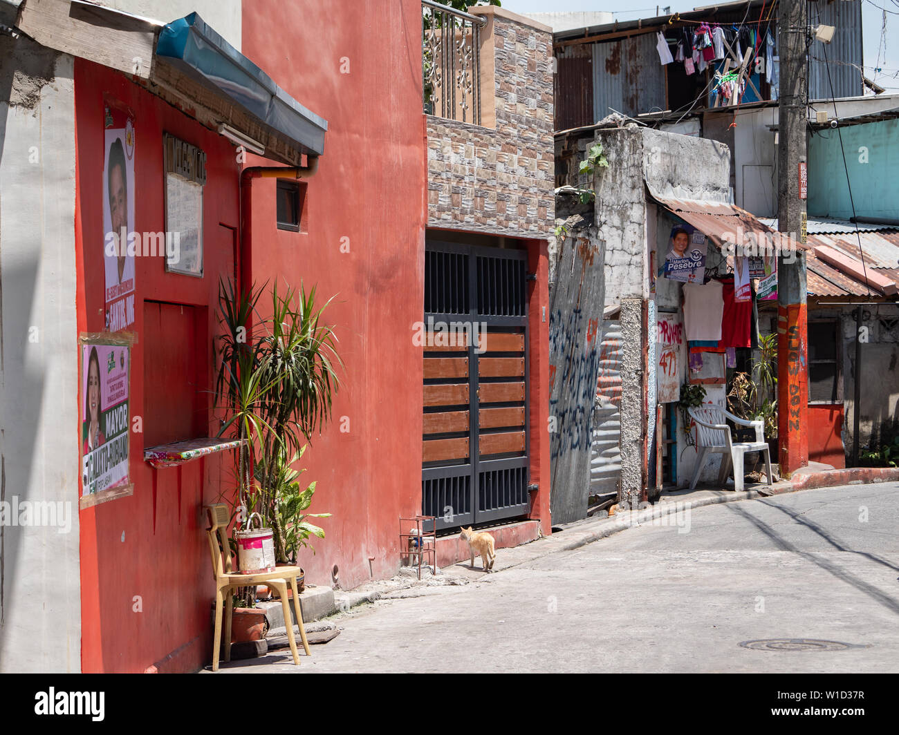 Manila, the Philippines - March 31, 2019: Back alley in the Malate district of downtown Manila. Metropolitan Manila features rich contrast between wid Stock Photo
