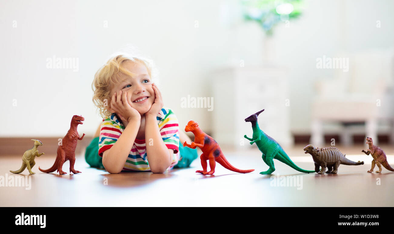 kids playing with dinosaur toys