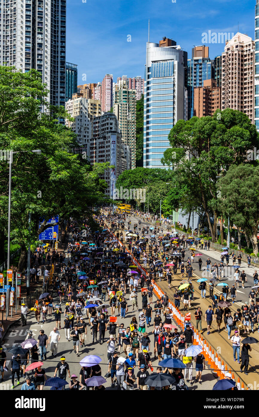 Hong Kong 2019 anti-extradition law protest march on July 1st, protesters carry umbrellas to protect themselves against the scorching sun Stock Photo